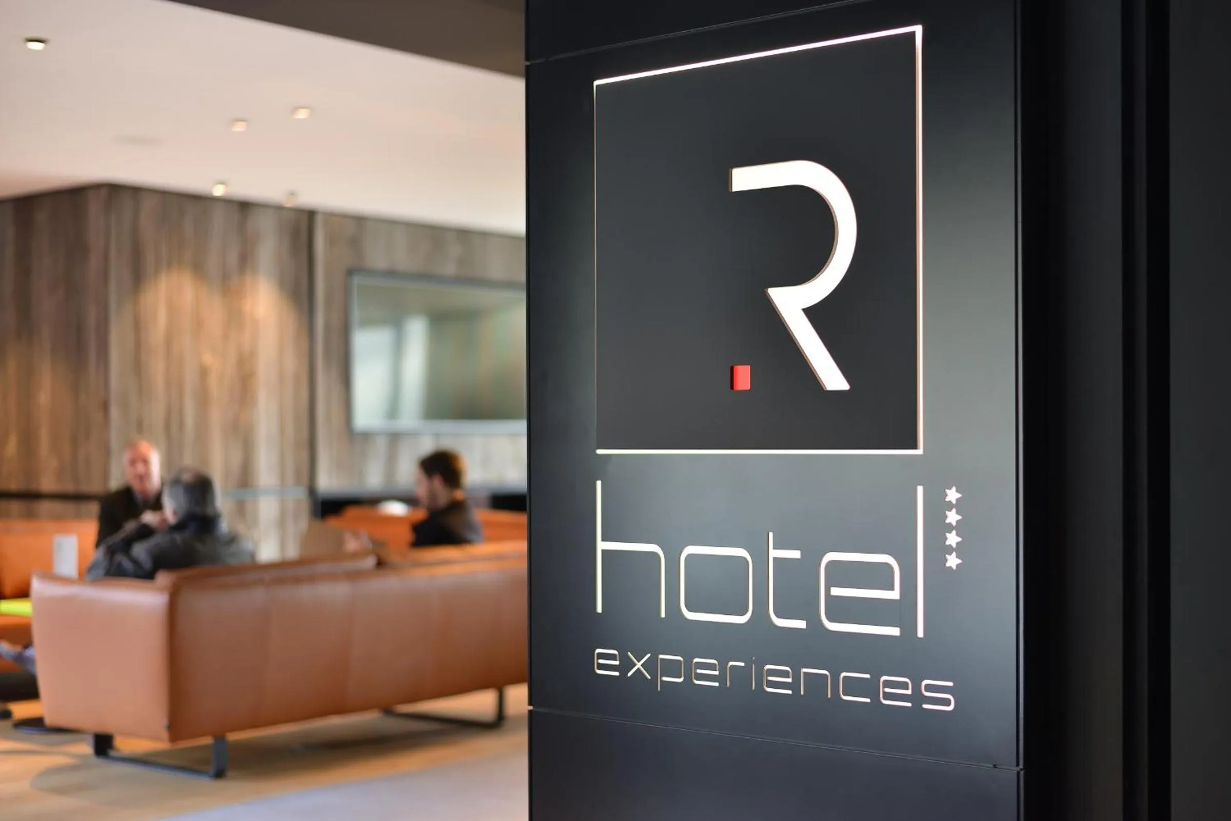 Property logo or sign in R hotel experiences