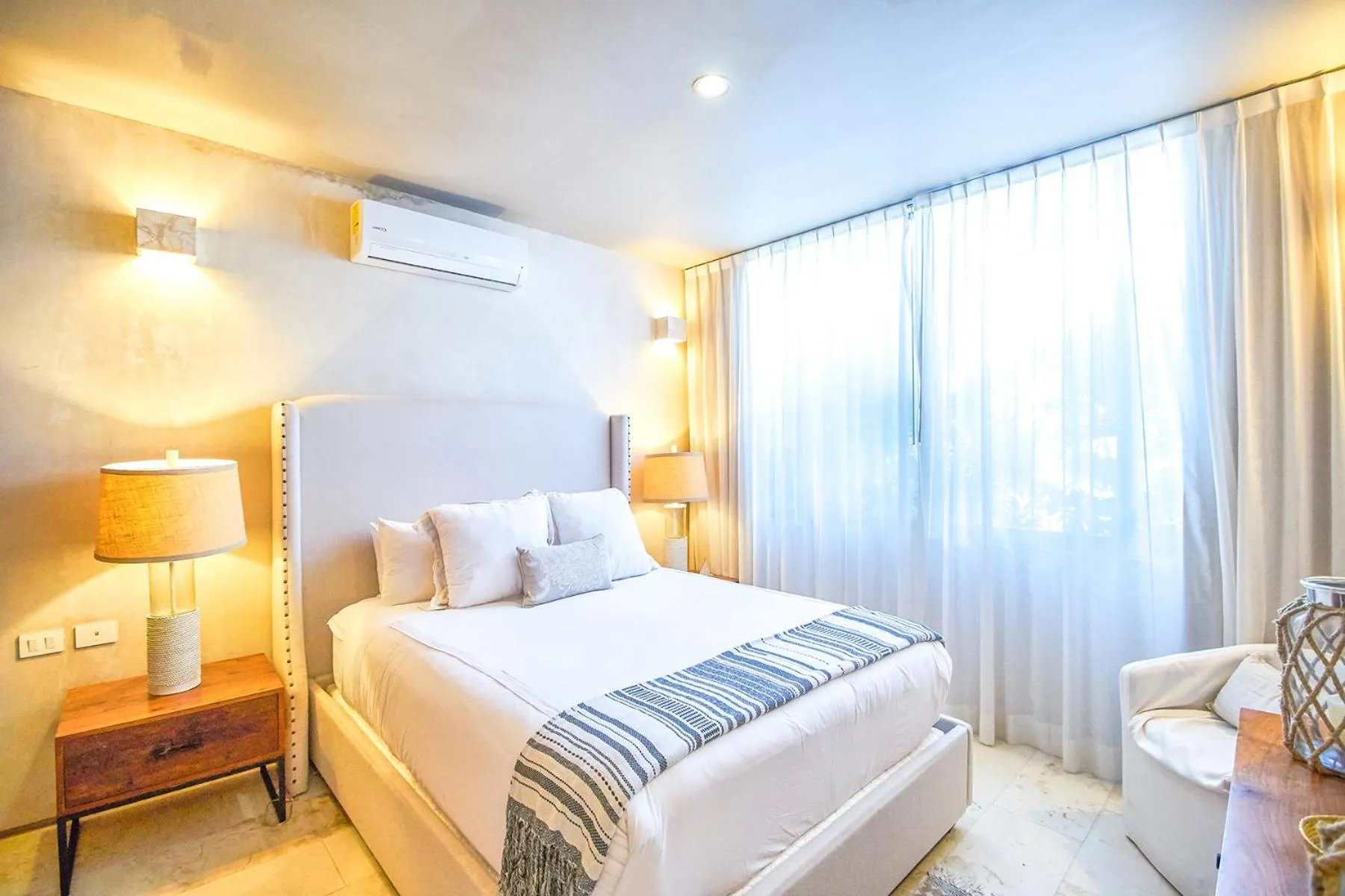 Bedroom, Bed in Eco-chic Design Condos Wrapped in Nature's Elements by Stella Rentals