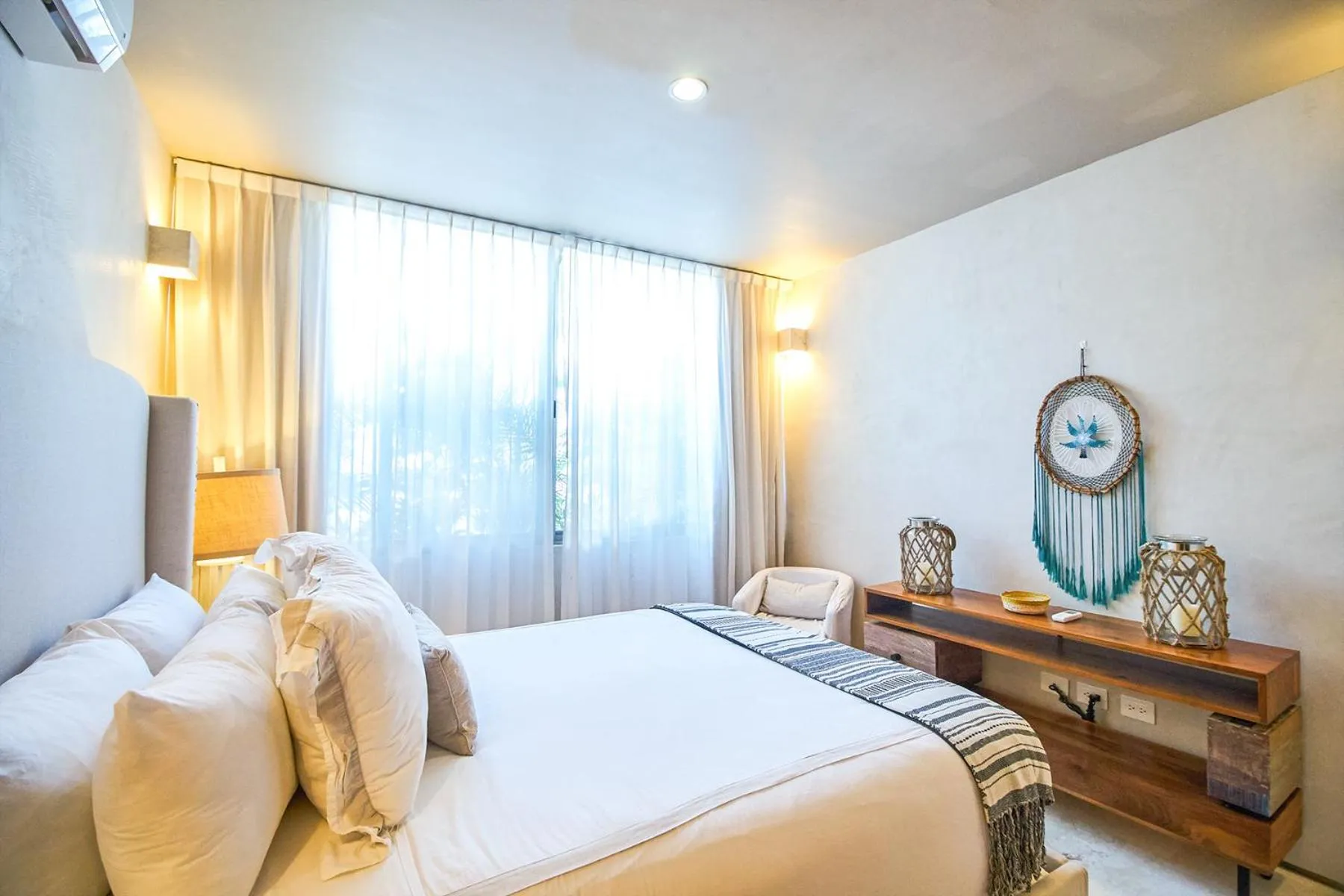 Bedroom, Bed in Eco-chic Design Condos Wrapped in Nature's Elements by Stella Rentals