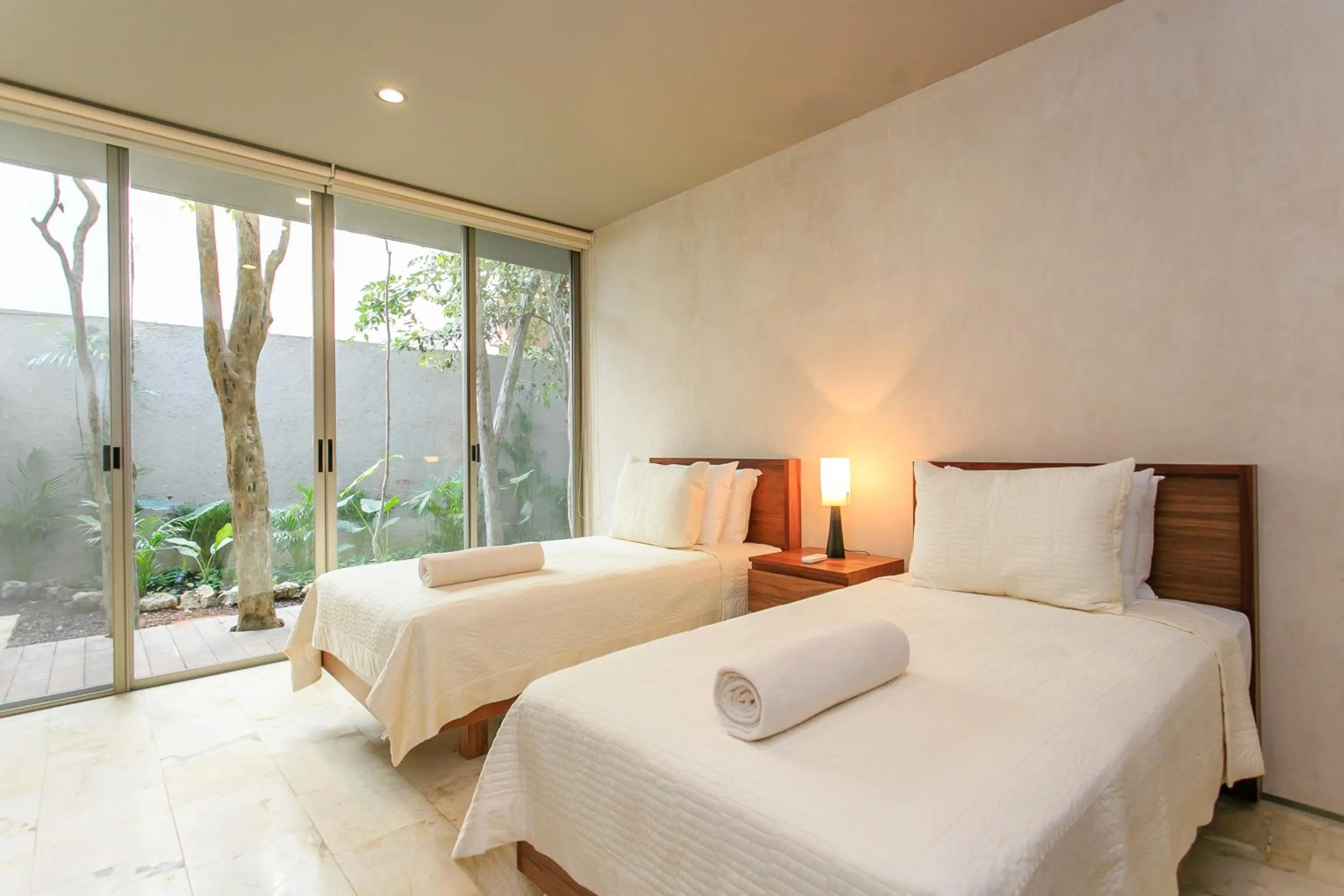 Bedroom, Bed in Eco-chic Design Condos Wrapped in Nature's Elements by Stella Rentals