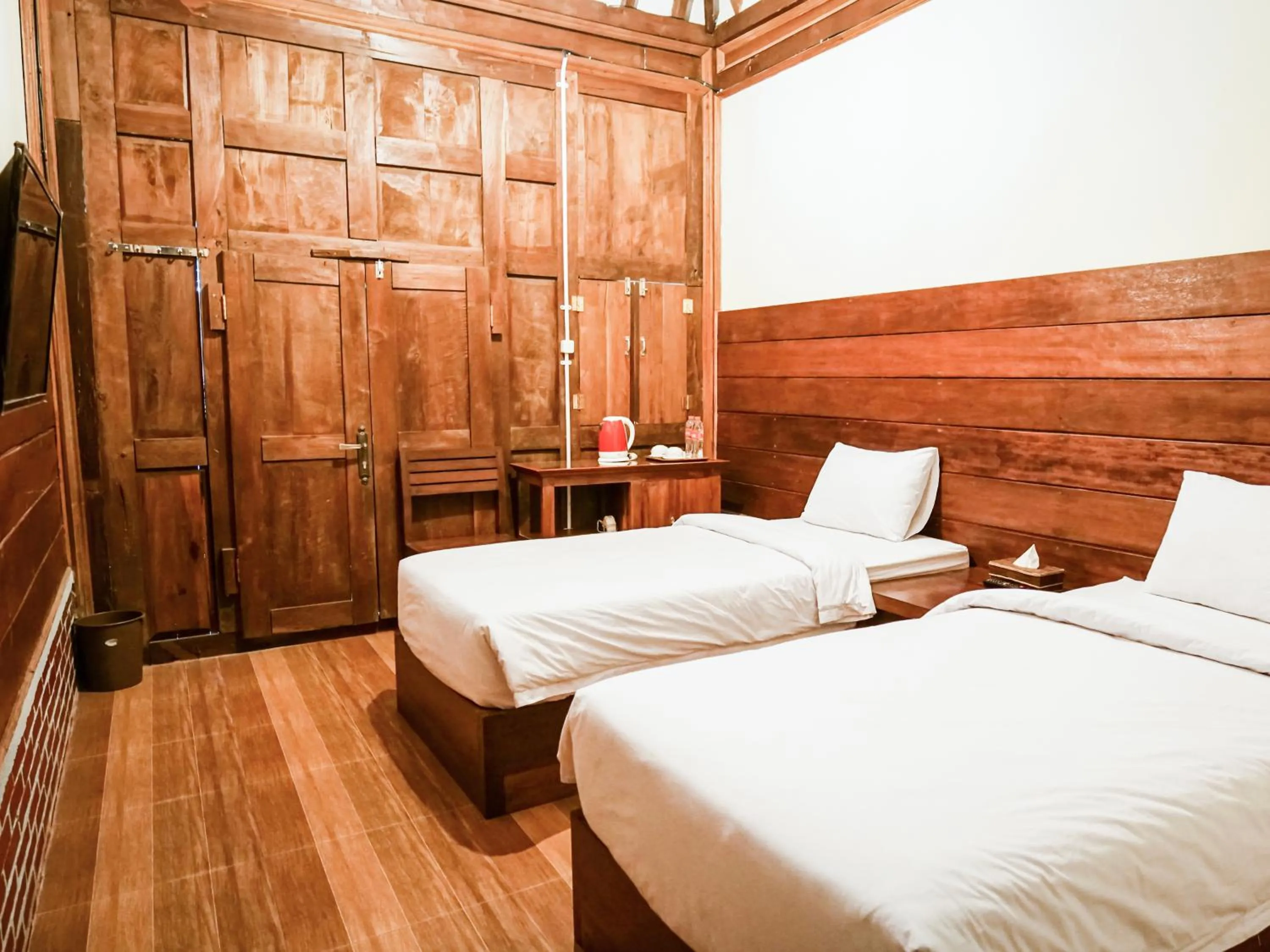 Bed in Pendhapa Art Space - PAS Limasan Homestay