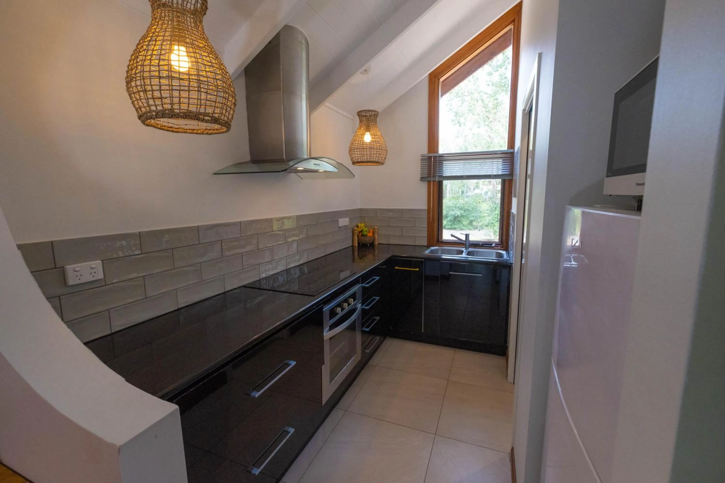 Kitchen or kitchenette in Airlie Beach Eco Cabins - Adults Only