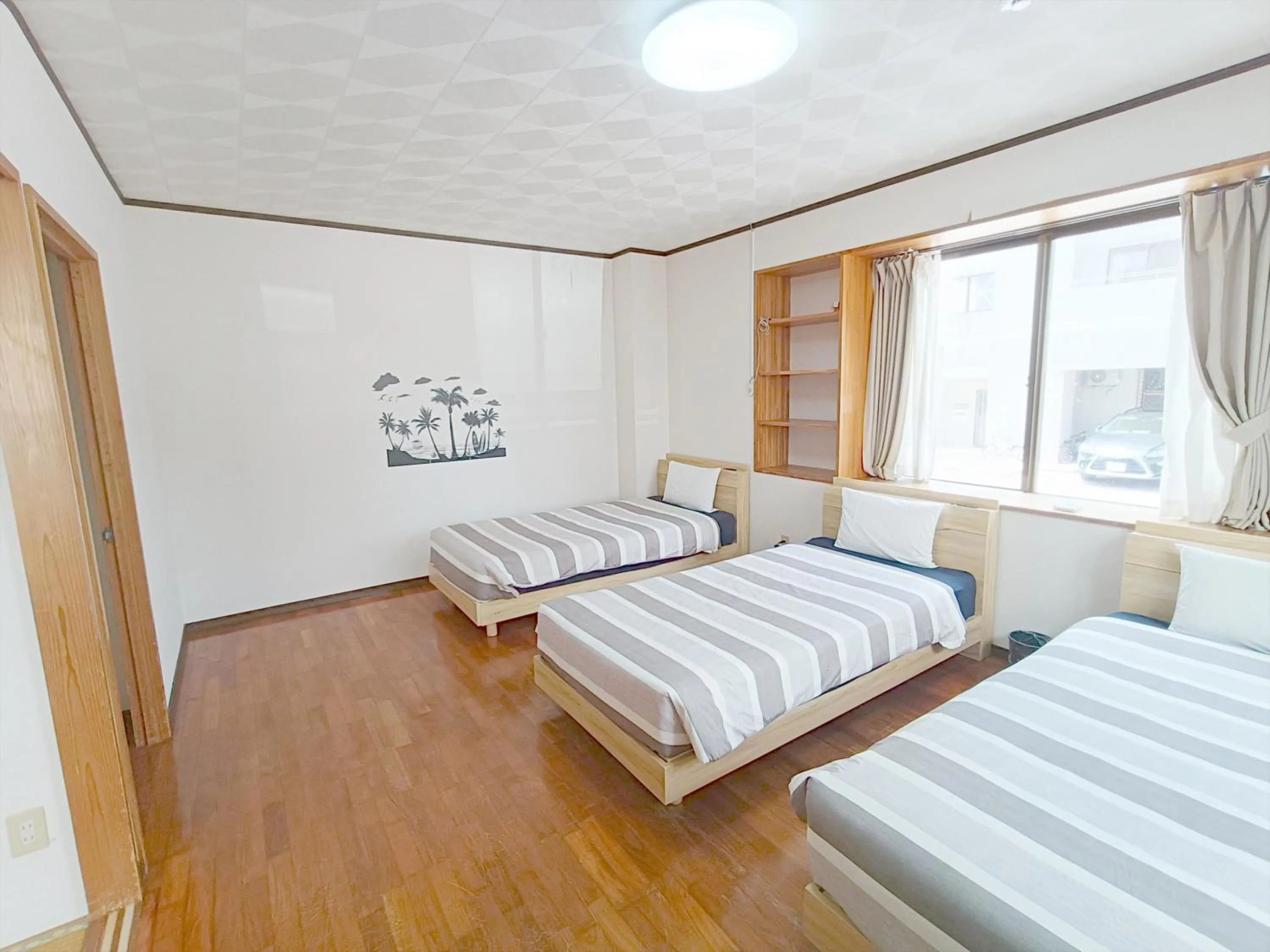 Bed in Kariyushi Condominium Resort Sea Side House