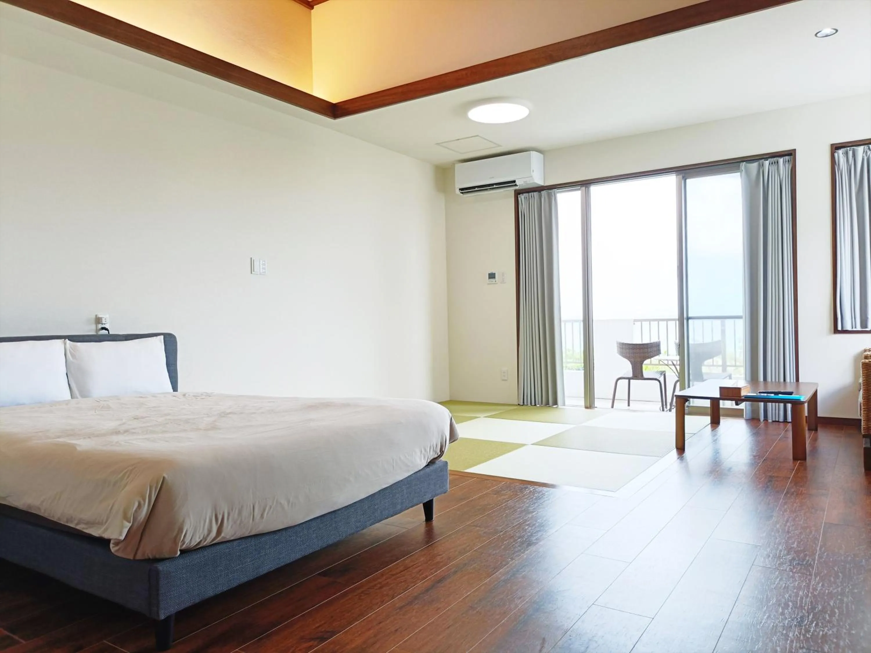 Bed in Kariyushi Condominium Resort Sea Side House