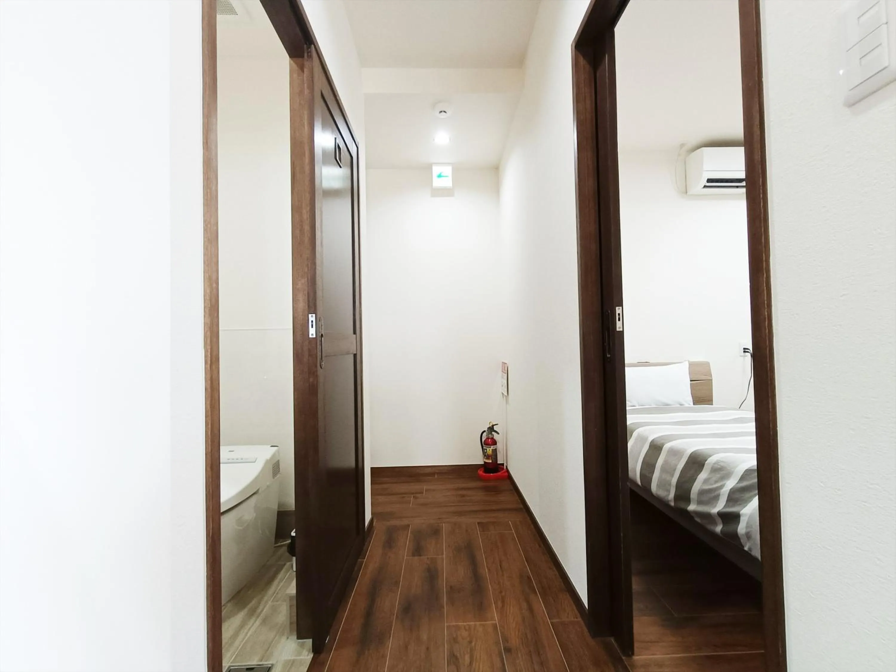 Bed in Kariyushi Condominium Resort Sea Side House