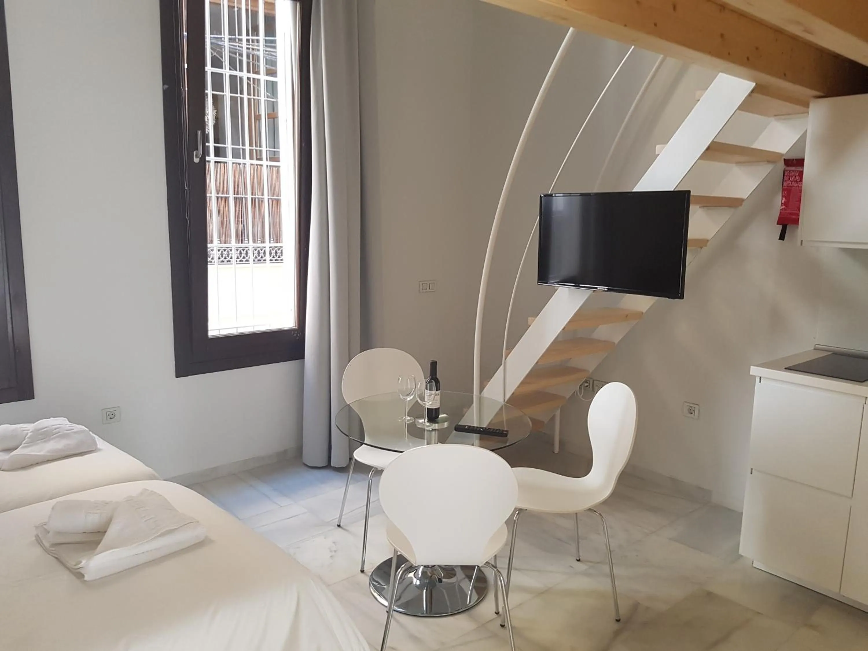 Dining area, Bed in Malaga City Breaks