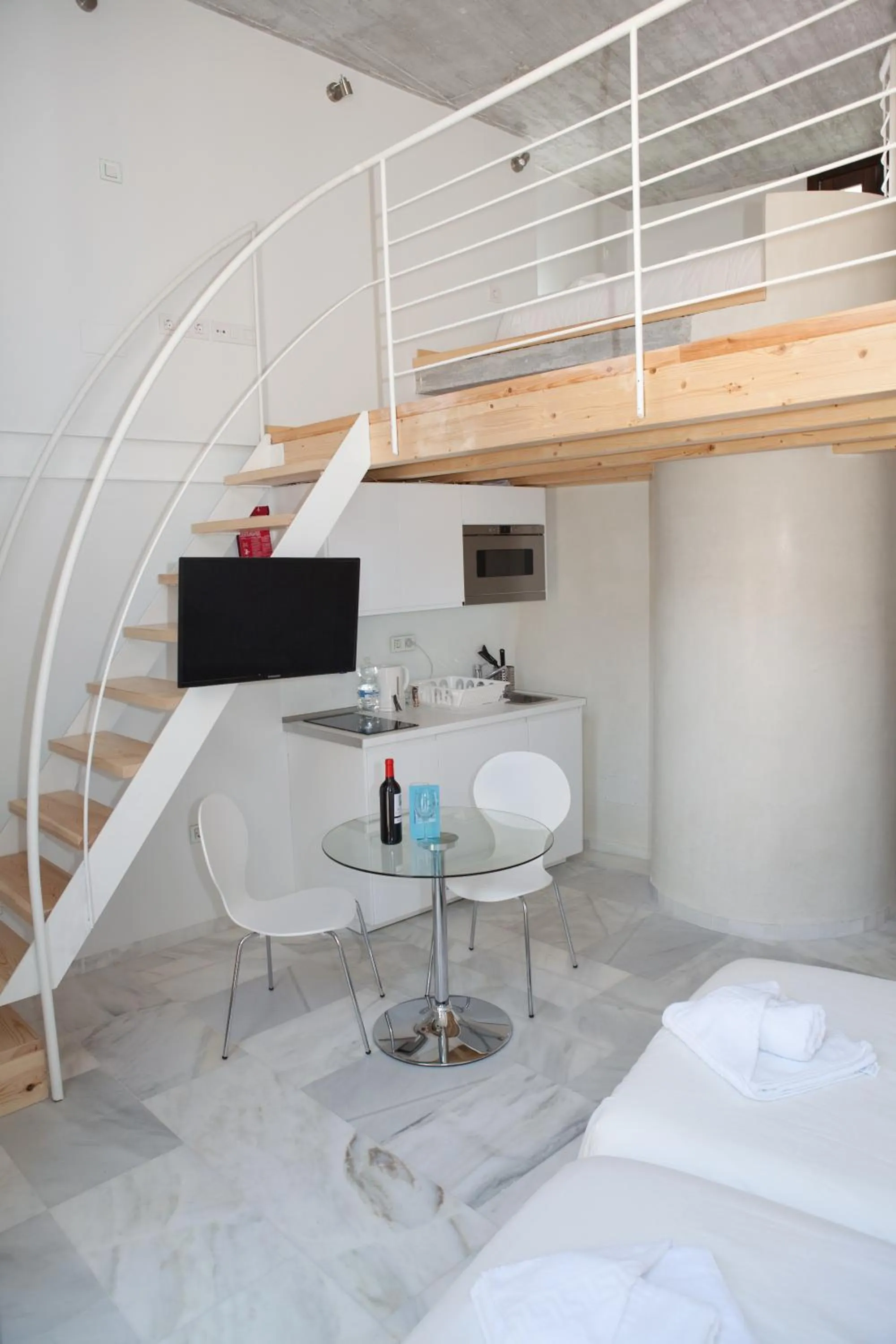 Dining area, Bed in Malaga City Breaks