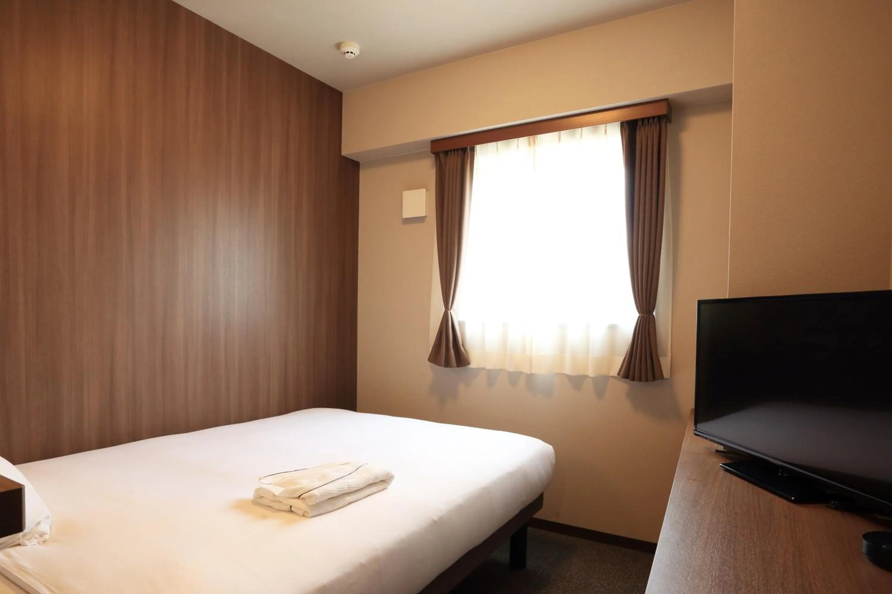 Bed in Smile Hotel Hakataekimae