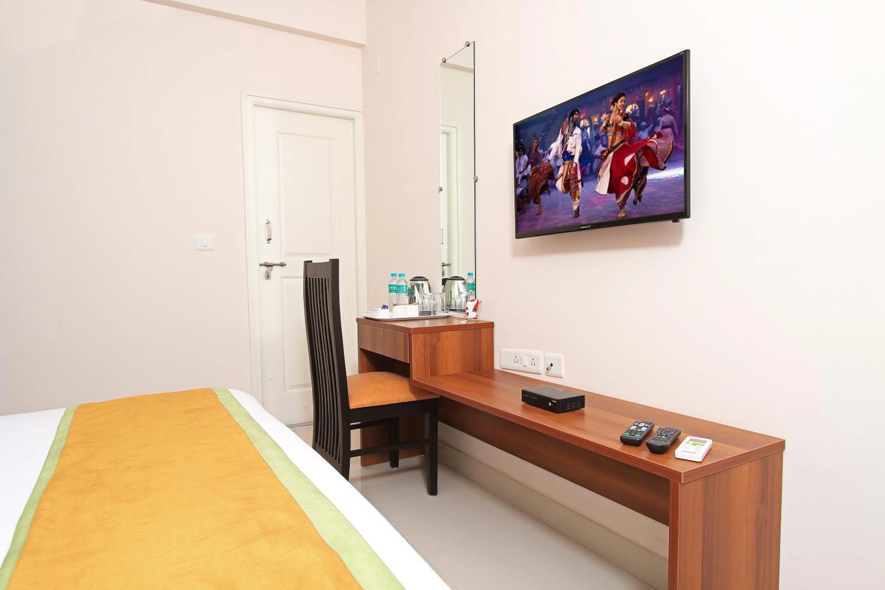 TV and multimedia, Bed in Arra Grande Suites - Nearest Airport Hotels Bangalore