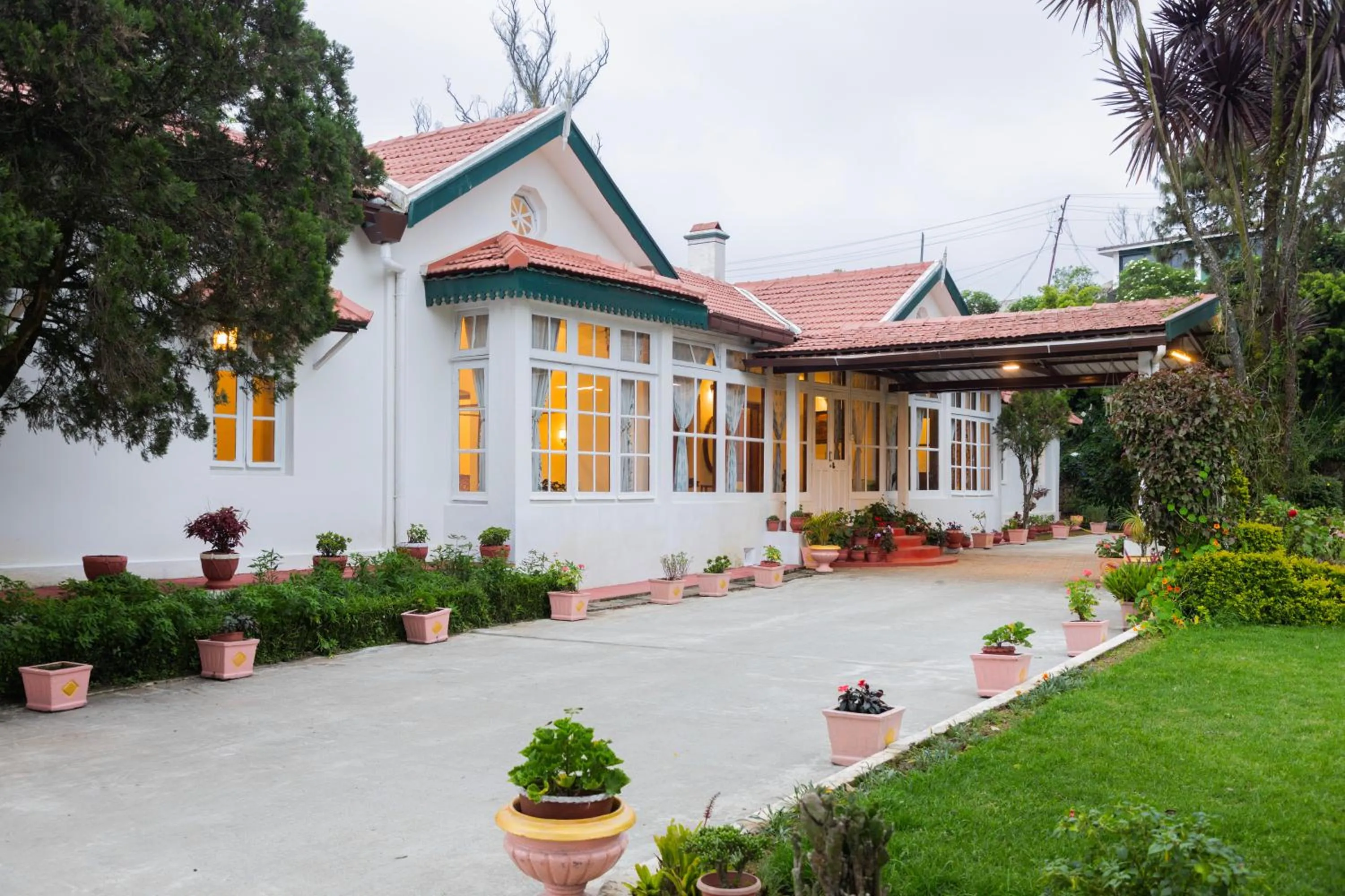 Property building in SaffronStays Milton Abbott Estate - 2BR colonial-era bungalow with garden, golf course views & bonfire nights near Ooty Golf Club