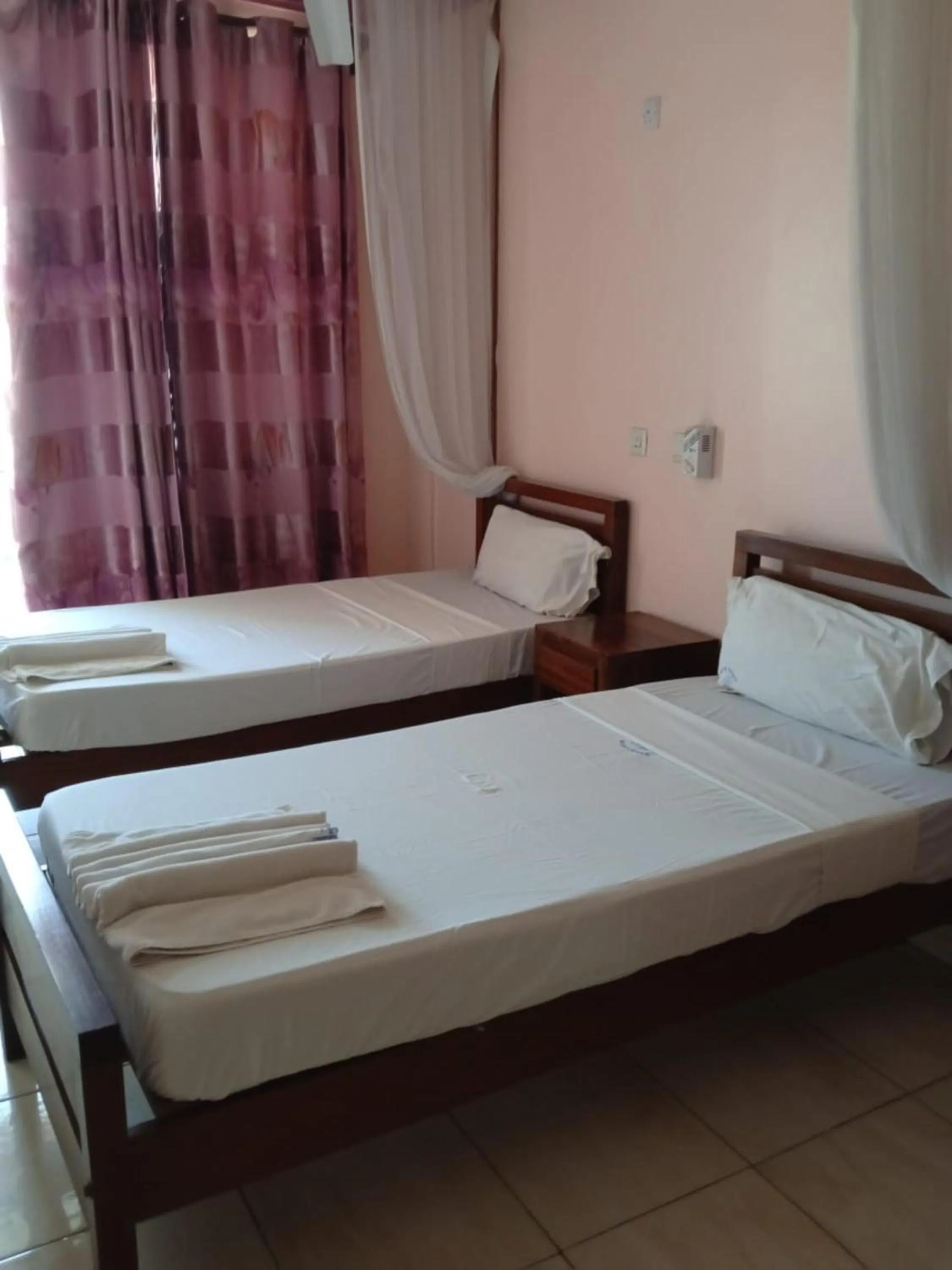 Bed in Checkpoint Inn Hotel, Mombasa