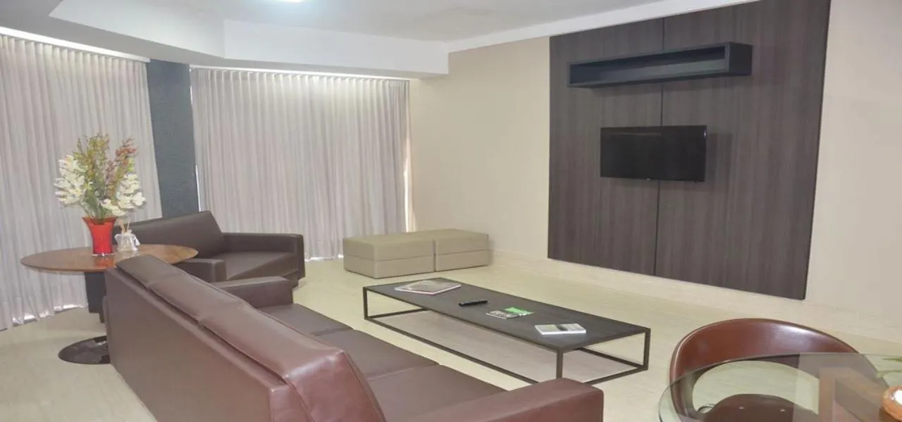 Communal lounge/ TV room in Racini Suites Hotel