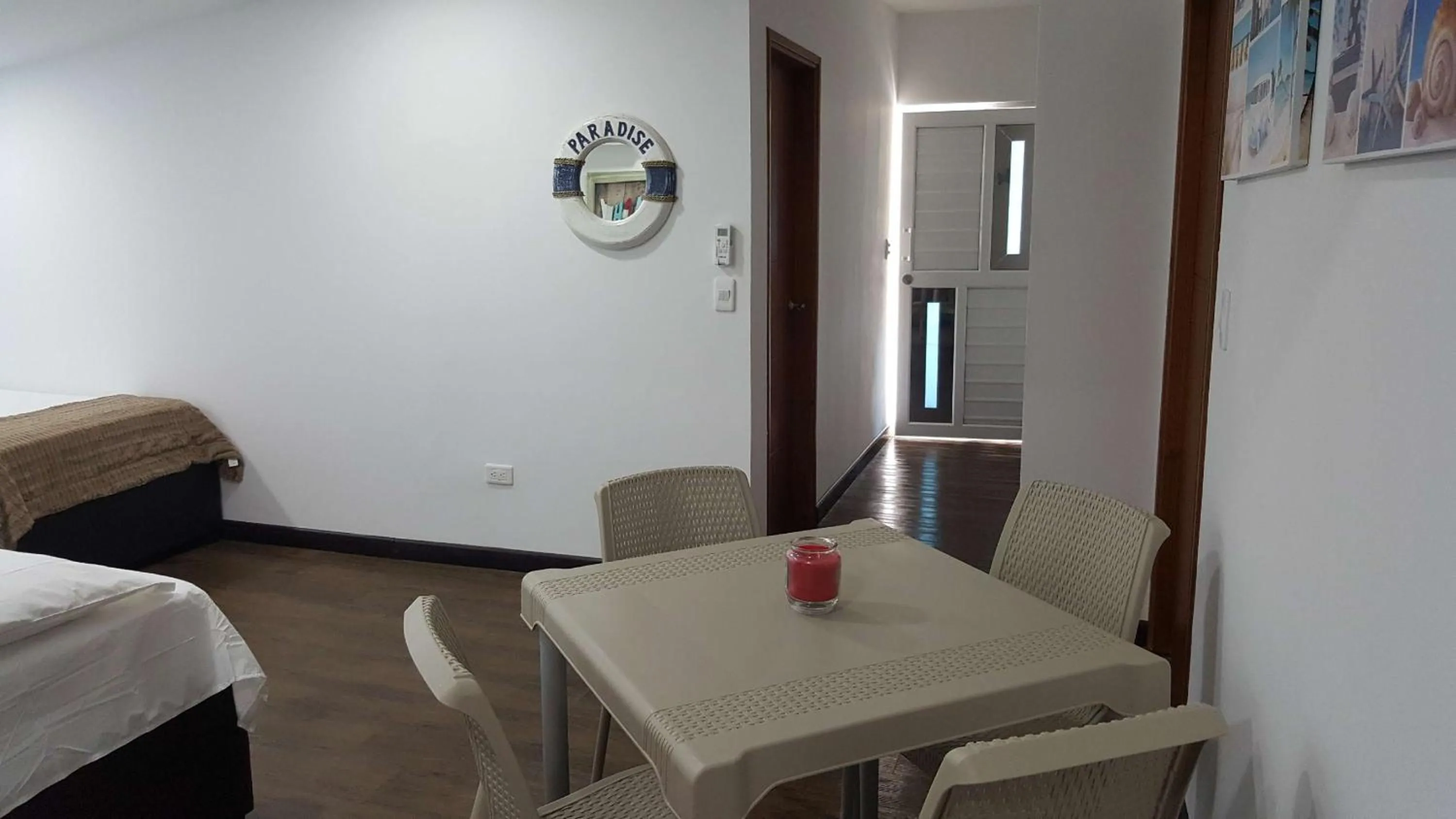 Dining area, Bed in Beach Paradise Apartments