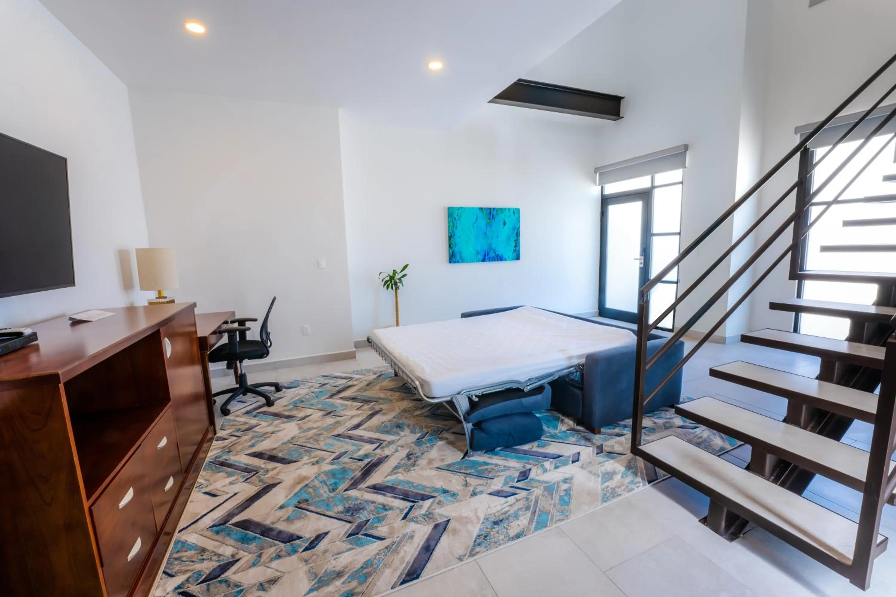 Communal lounge/ TV room, Bed in Laguna Shores Resort