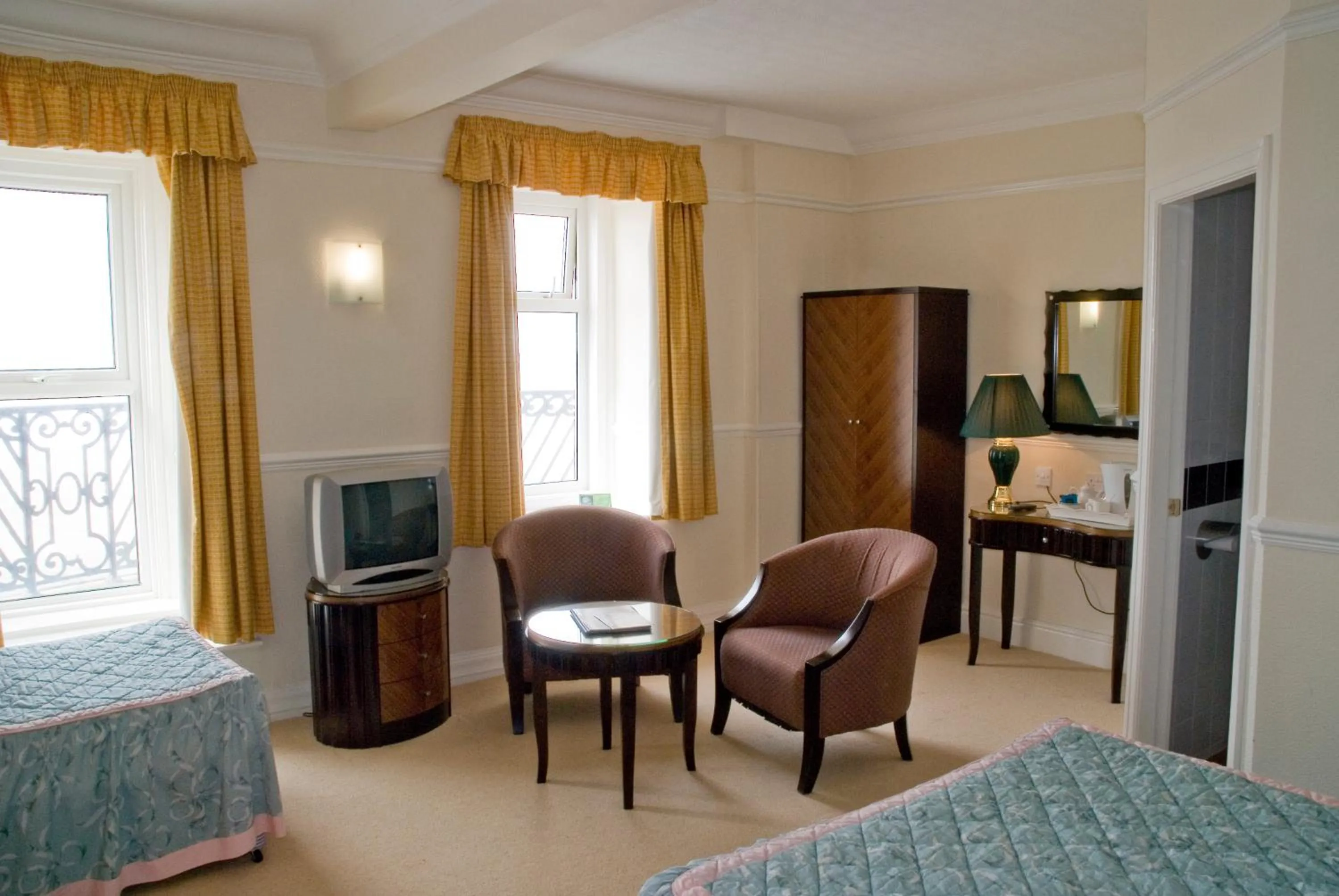 Communal lounge/ TV room in The Metropole Hotel