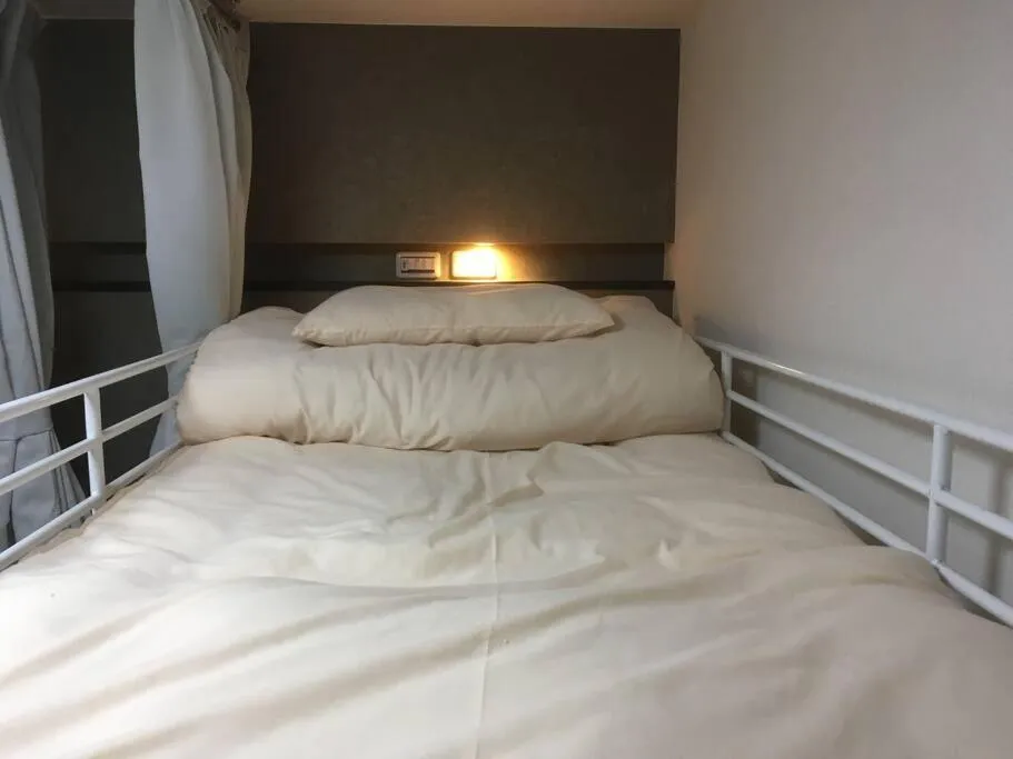 Bed in Keimei Guest House