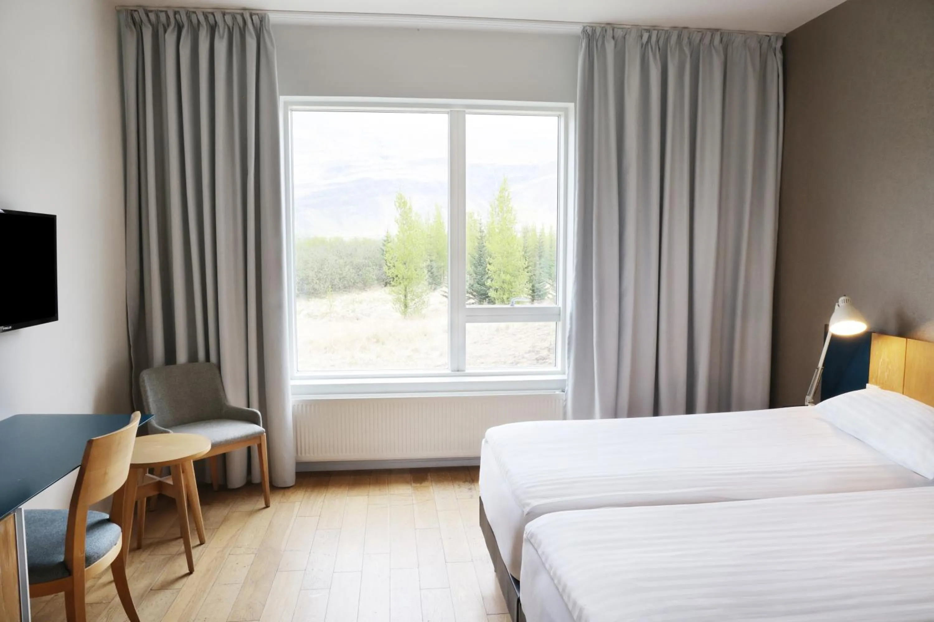 Communal lounge/ TV room, Bed in Fosshotel Vatnajökull