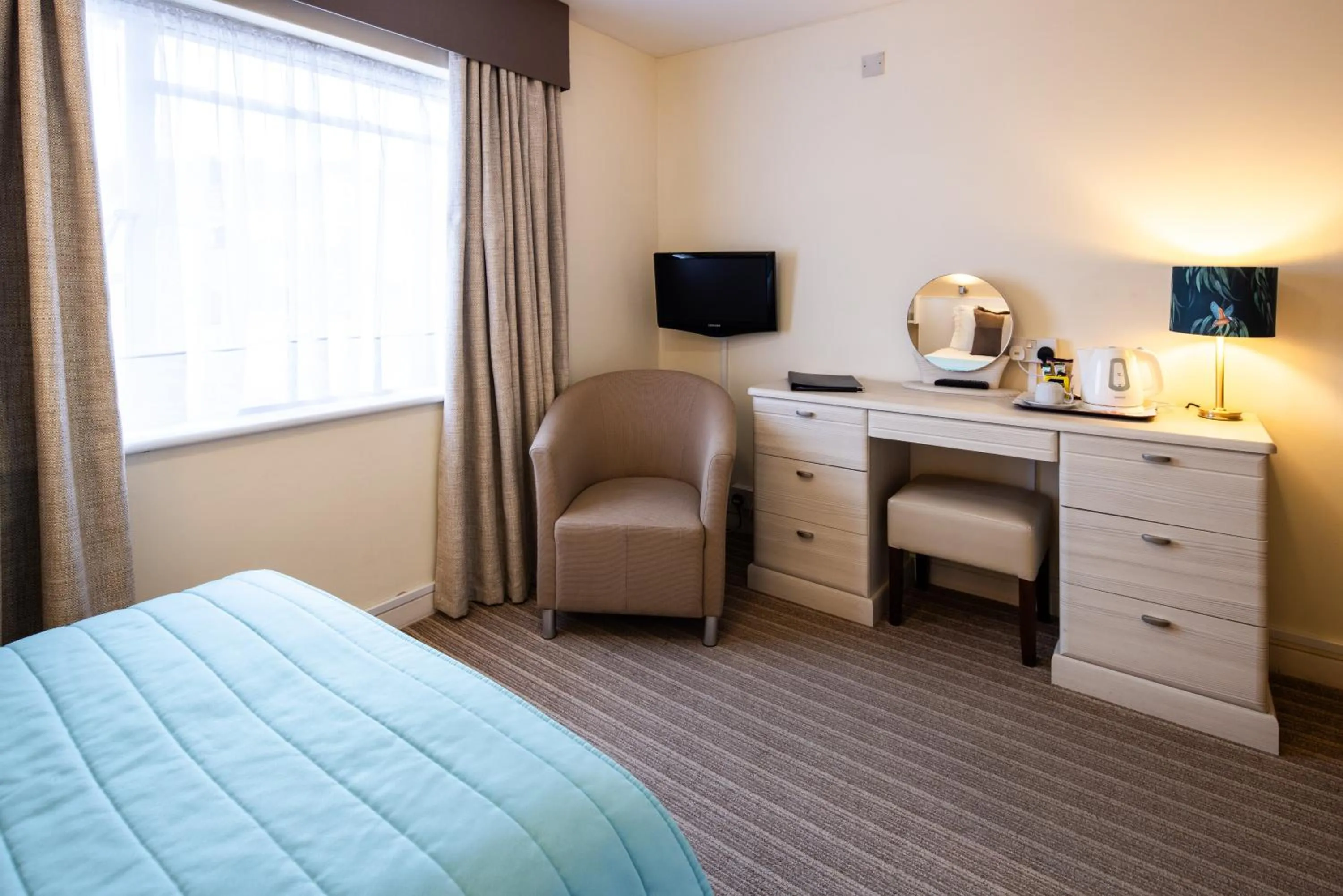 Bed in The Norfolk Lodge Hotel