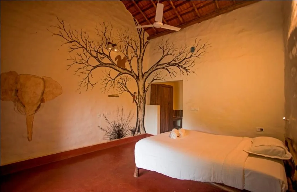 Bed in Deshadan Eco Valley Resort - An Eco friendly Mud House