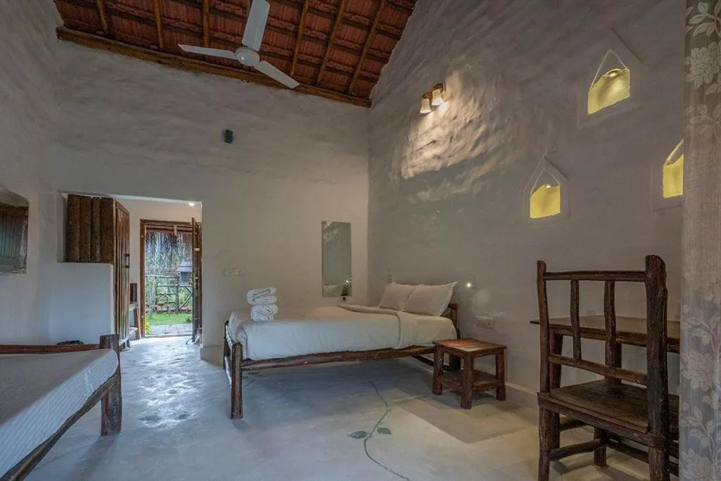 Bed in Deshadan Eco Valley Resort - An Eco friendly Mud House