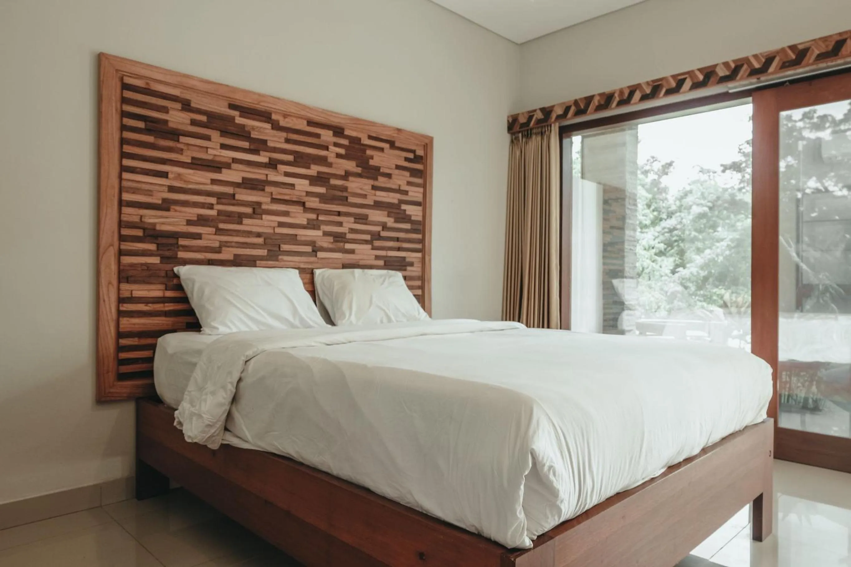 Photo of the whole room, Bed in Sekar Arum Riverside Resort in Canggu