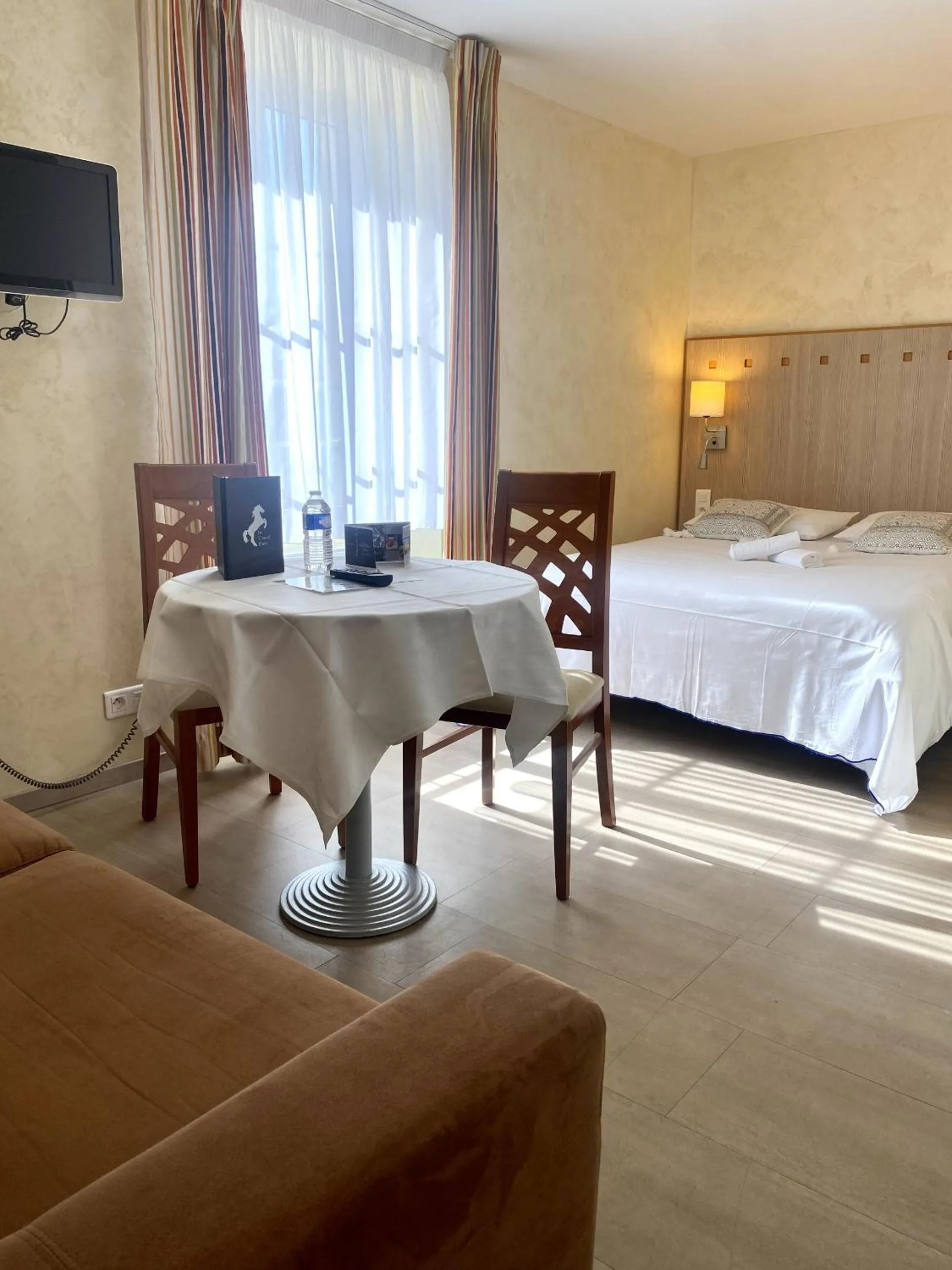 Photo of the whole room, Bed in Logis Hôtel & Restaurant Le Cheval Blanc et Clovis