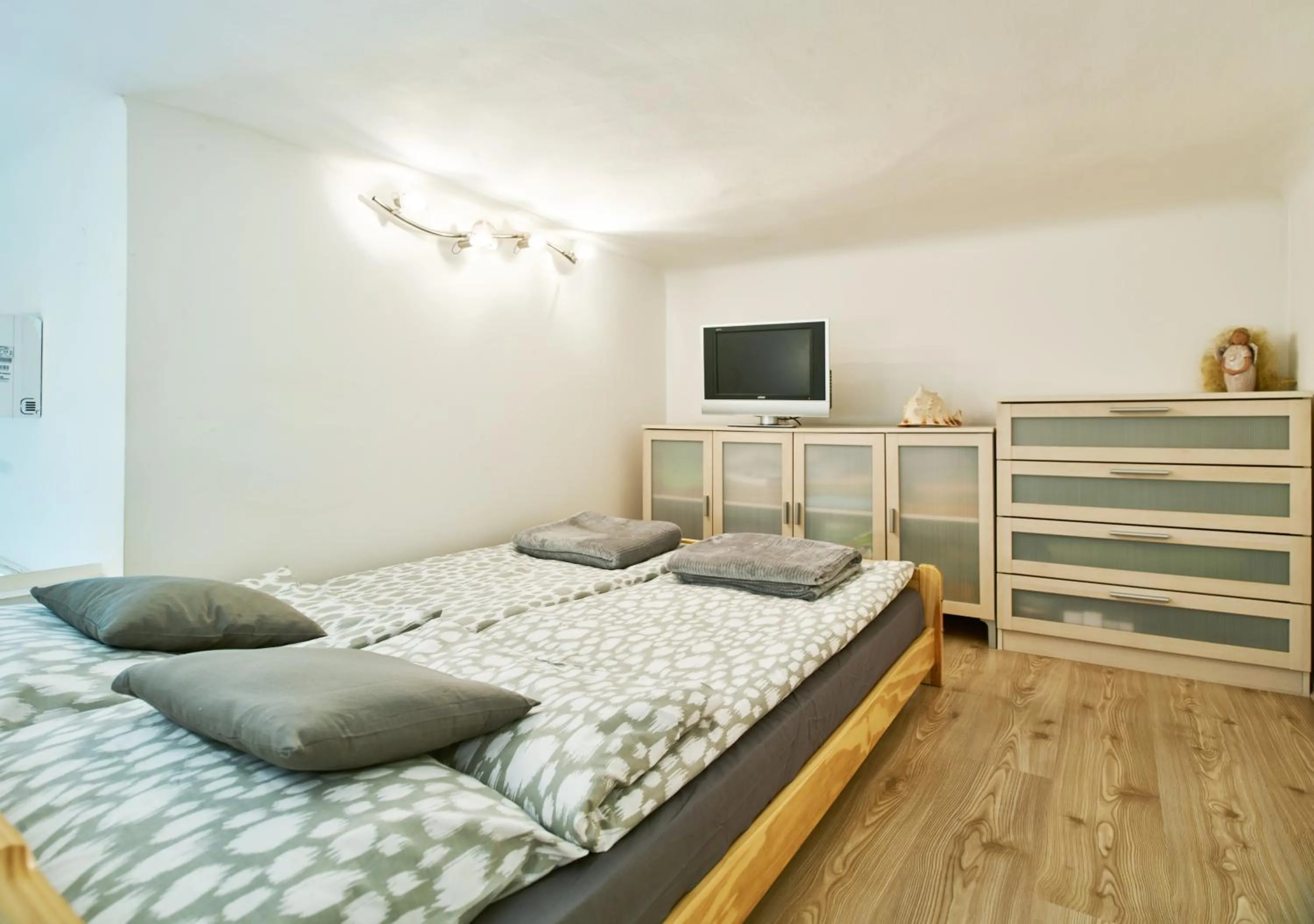 Bedroom, Bed in Studio Apartment Green Wall