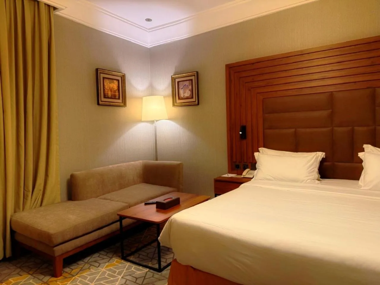 Seating area, Bed in Crown Town Hotel