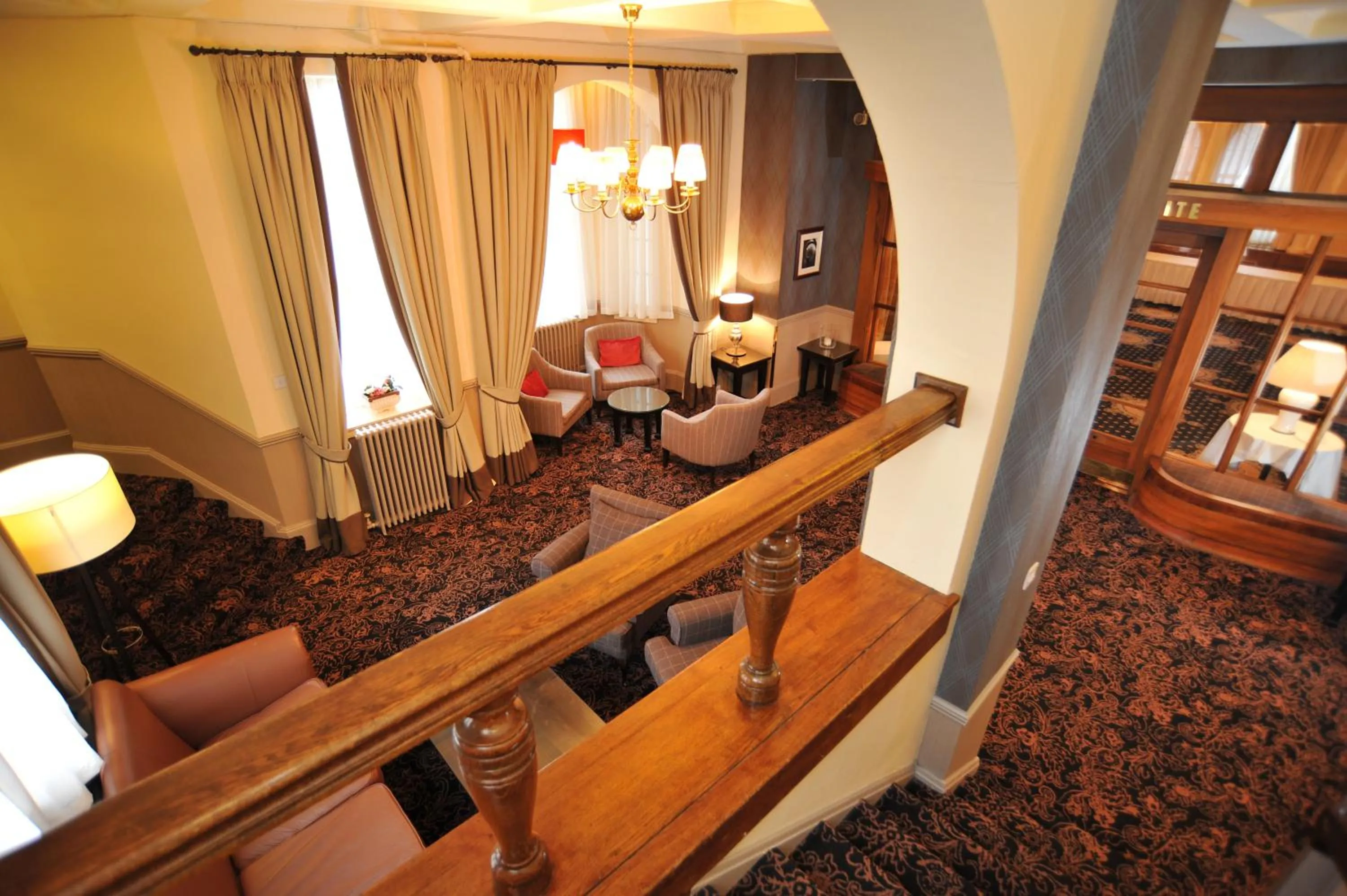 Communal lounge/ TV room in Golden Lion Hotel