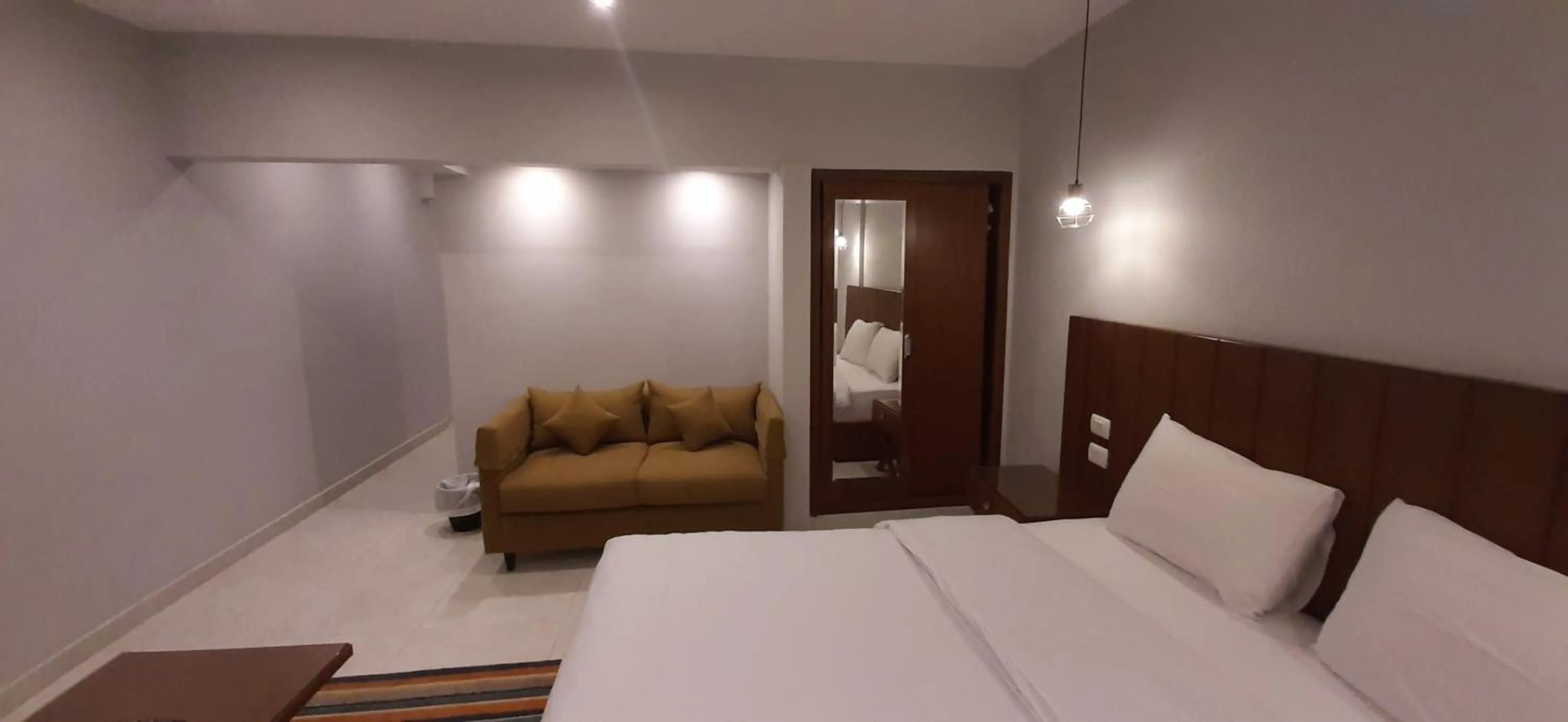 Seating area, Bed in Nakhil Inn Residence