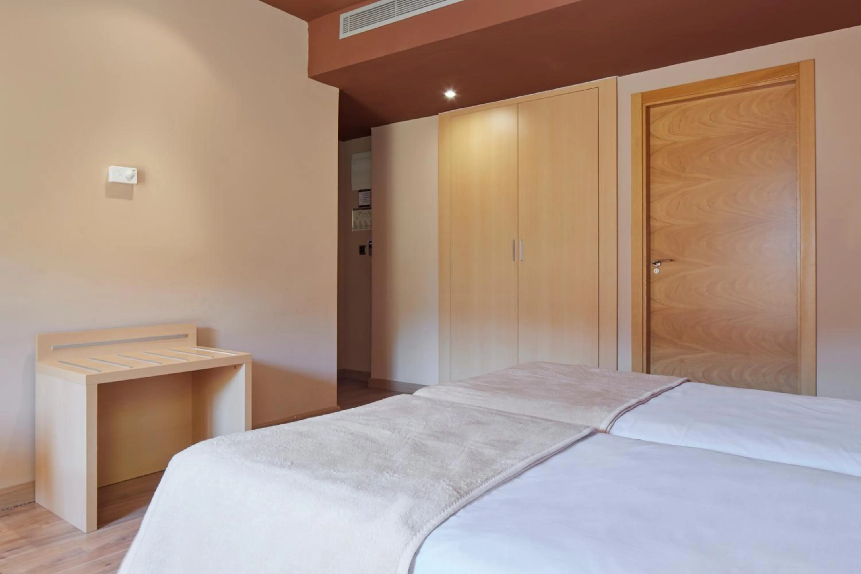 Text overlay, Bed in Iraipe Santuario de Arantzazu Hotel