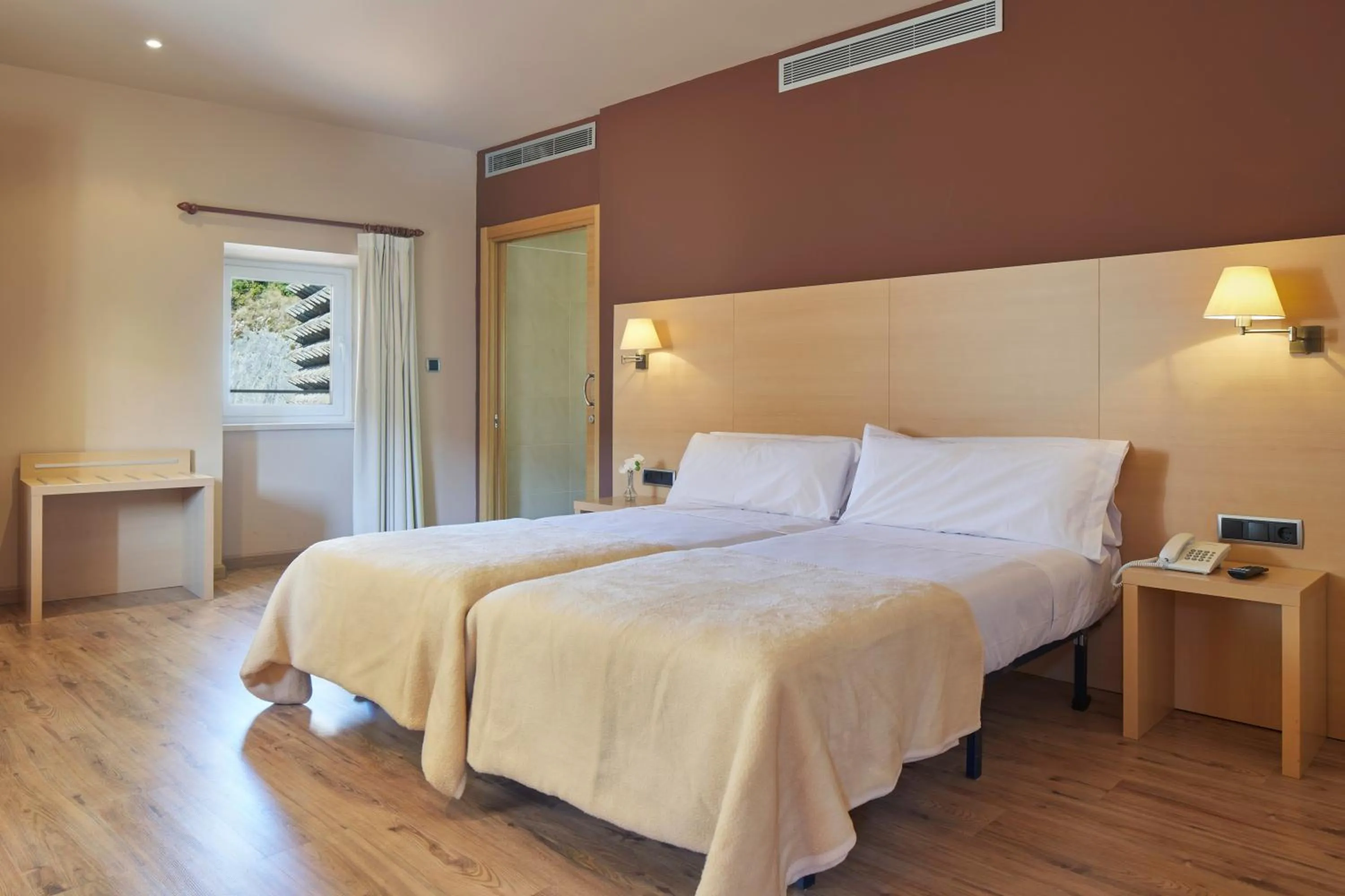 Text overlay, Bed in Iraipe Santuario de Arantzazu Hotel