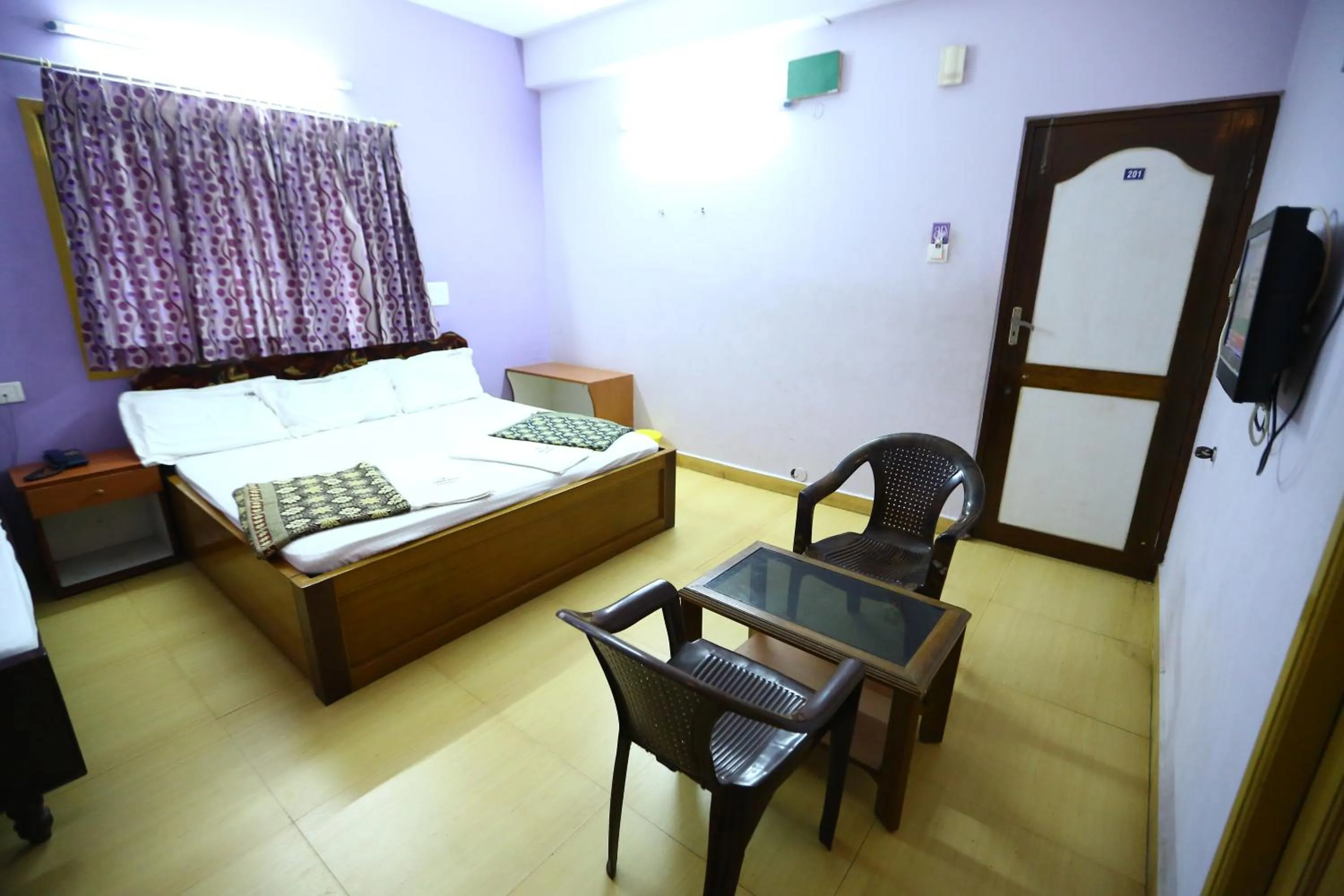 Seating area, Bed in Abirami Residency