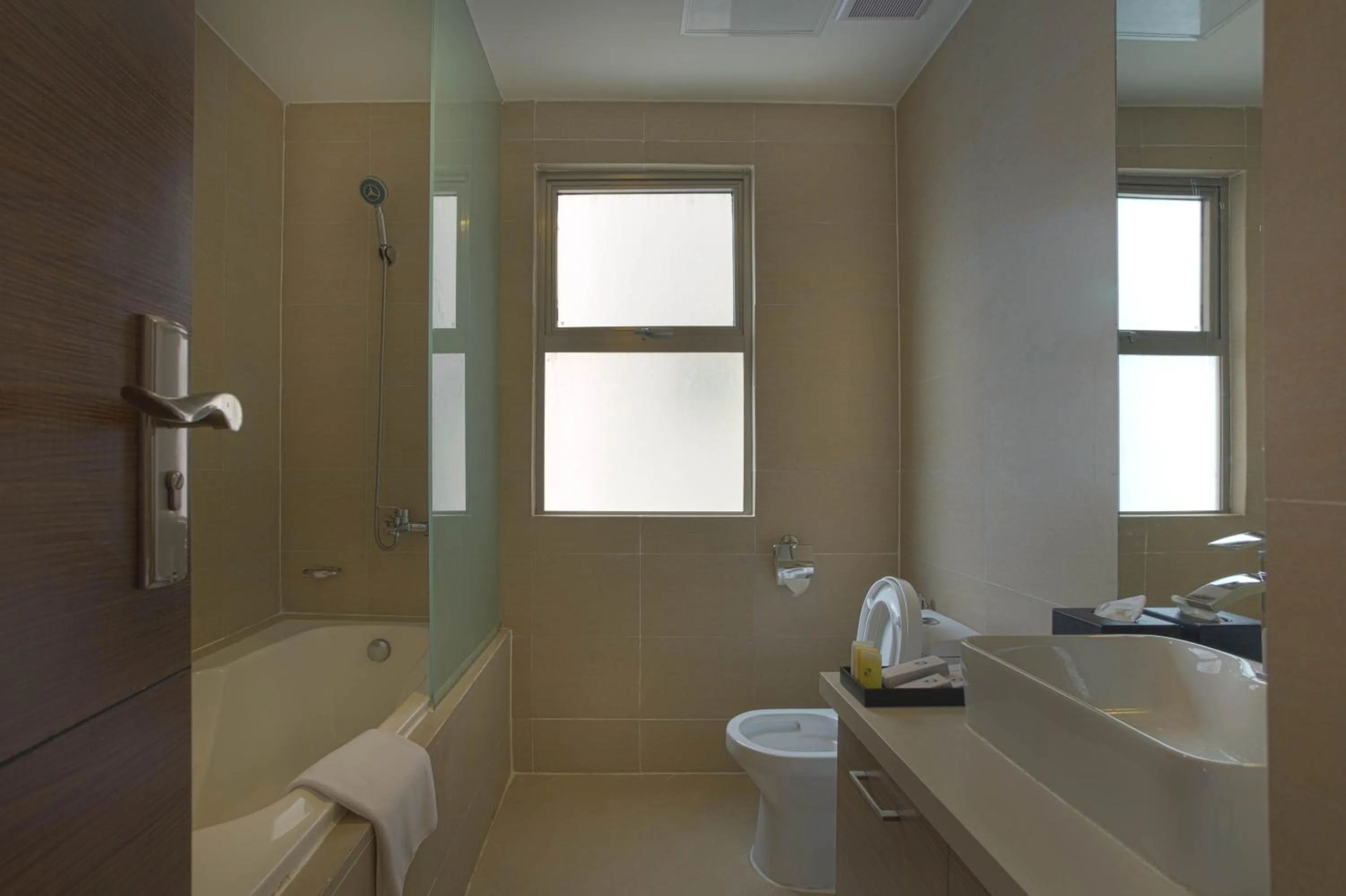 Toilet in Valero Grand Suites by Swiss-Belhotel