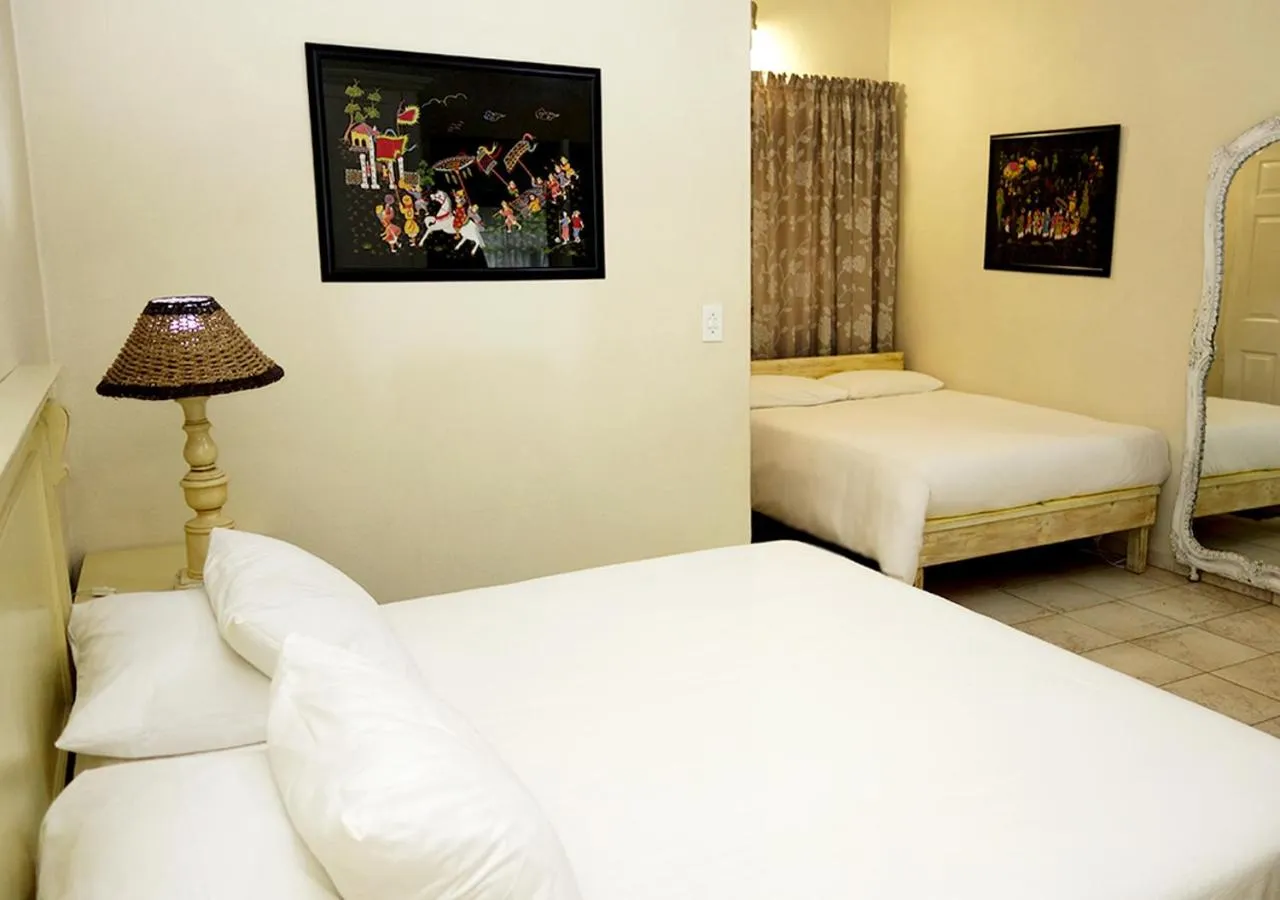 Bed in Veki's Village Cottages