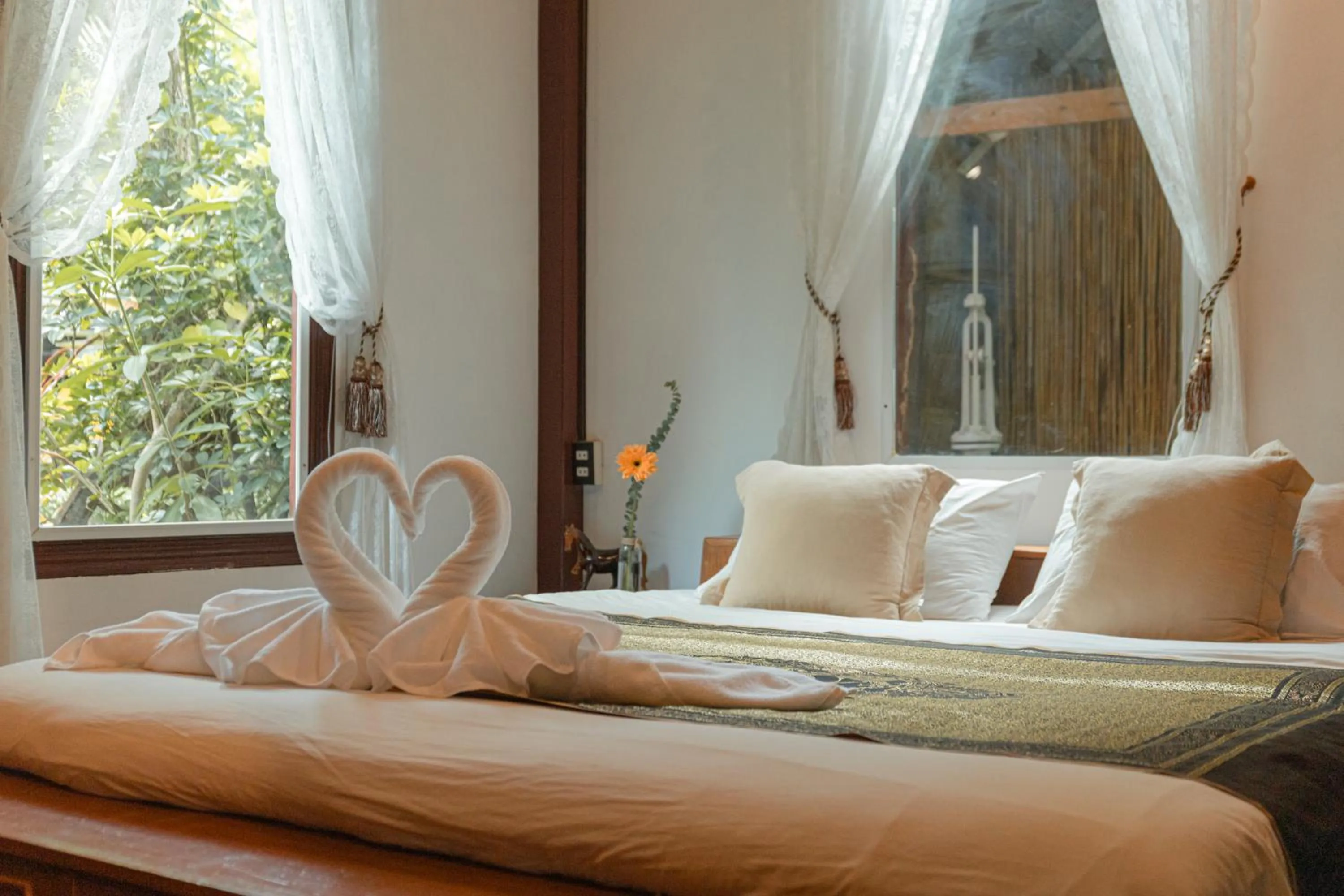 Bed in The Antique Riverside Resort