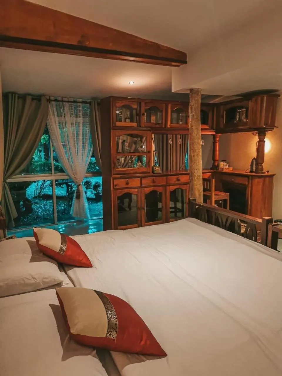 Bed in The Antique Riverside Resort