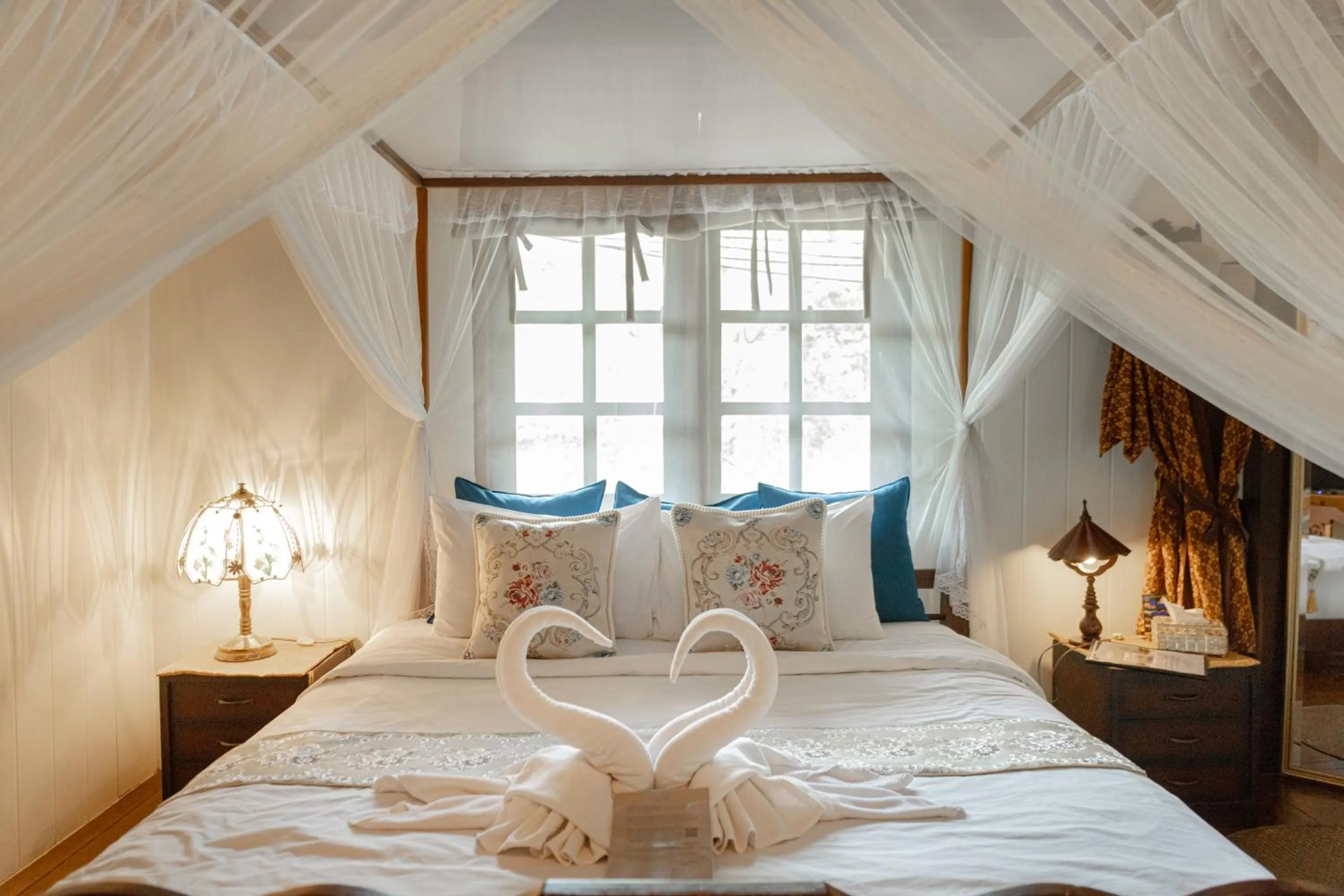 Bed in The Antique Riverside Resort