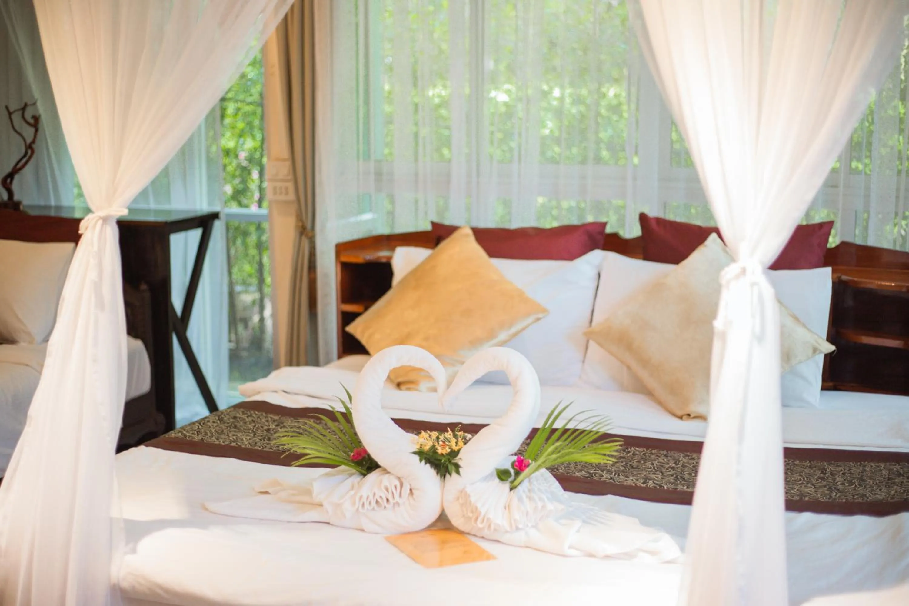 Bed in The Antique Riverside Resort