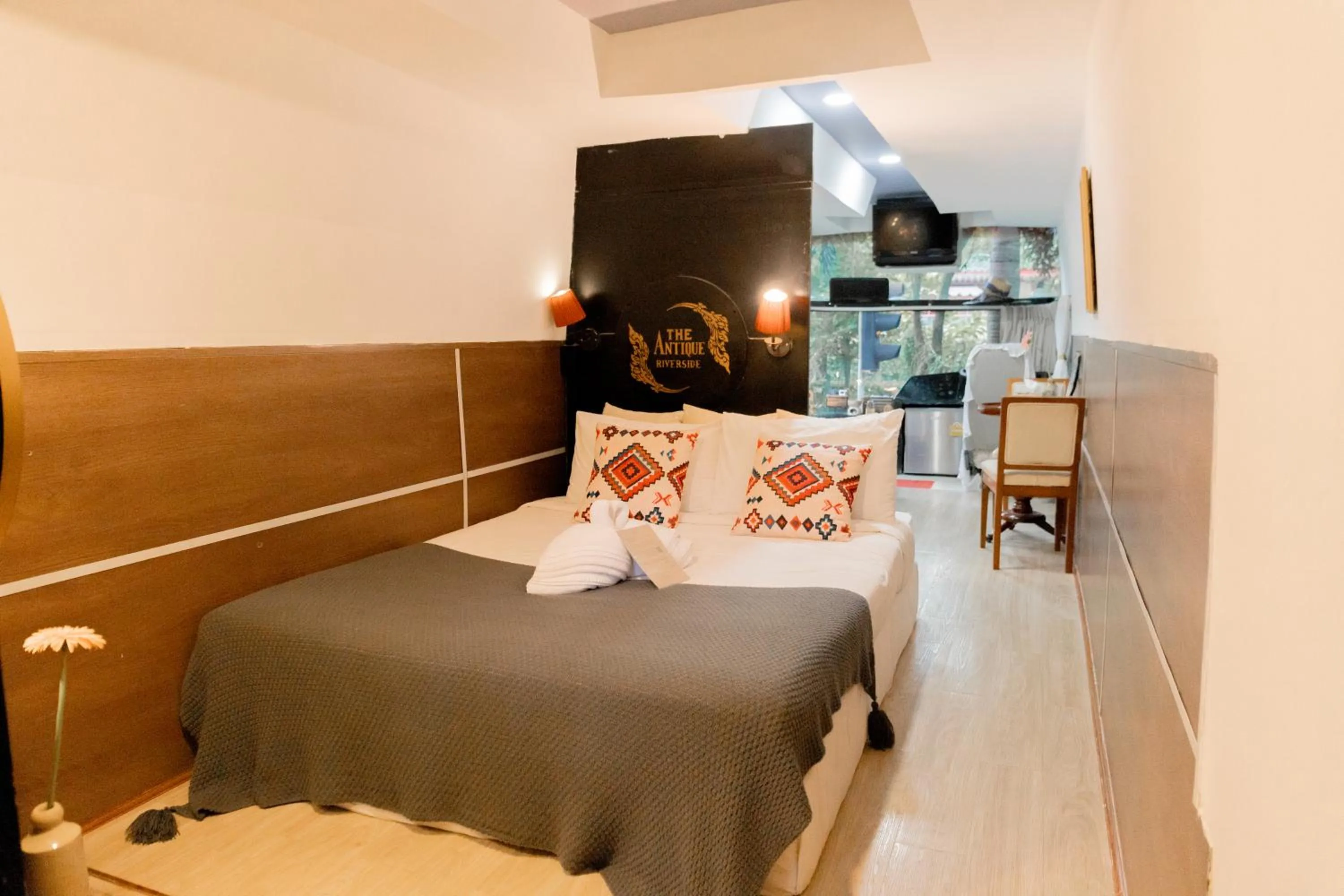 Bed in The Antique Riverside Resort