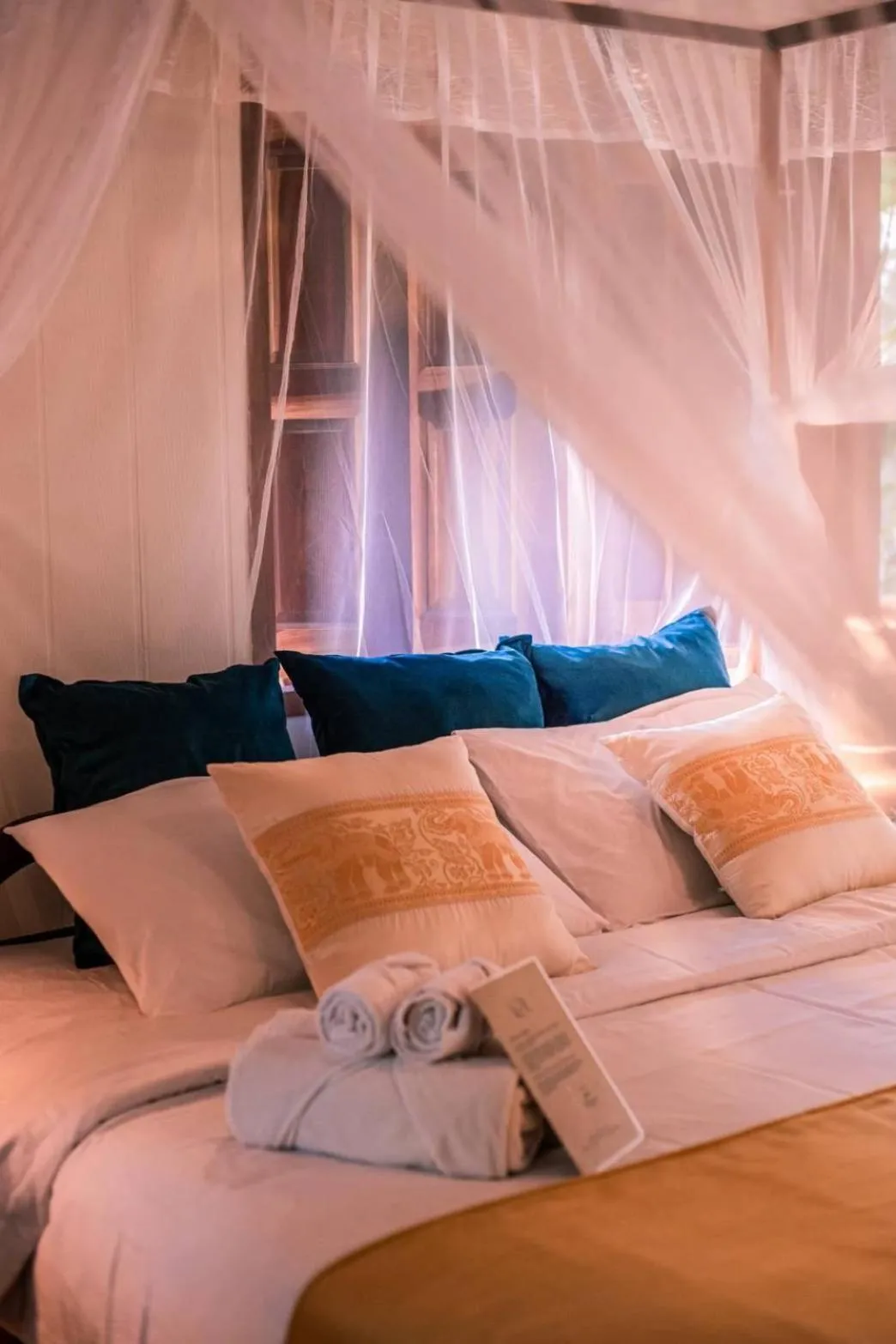 Bed in The Antique Riverside Resort