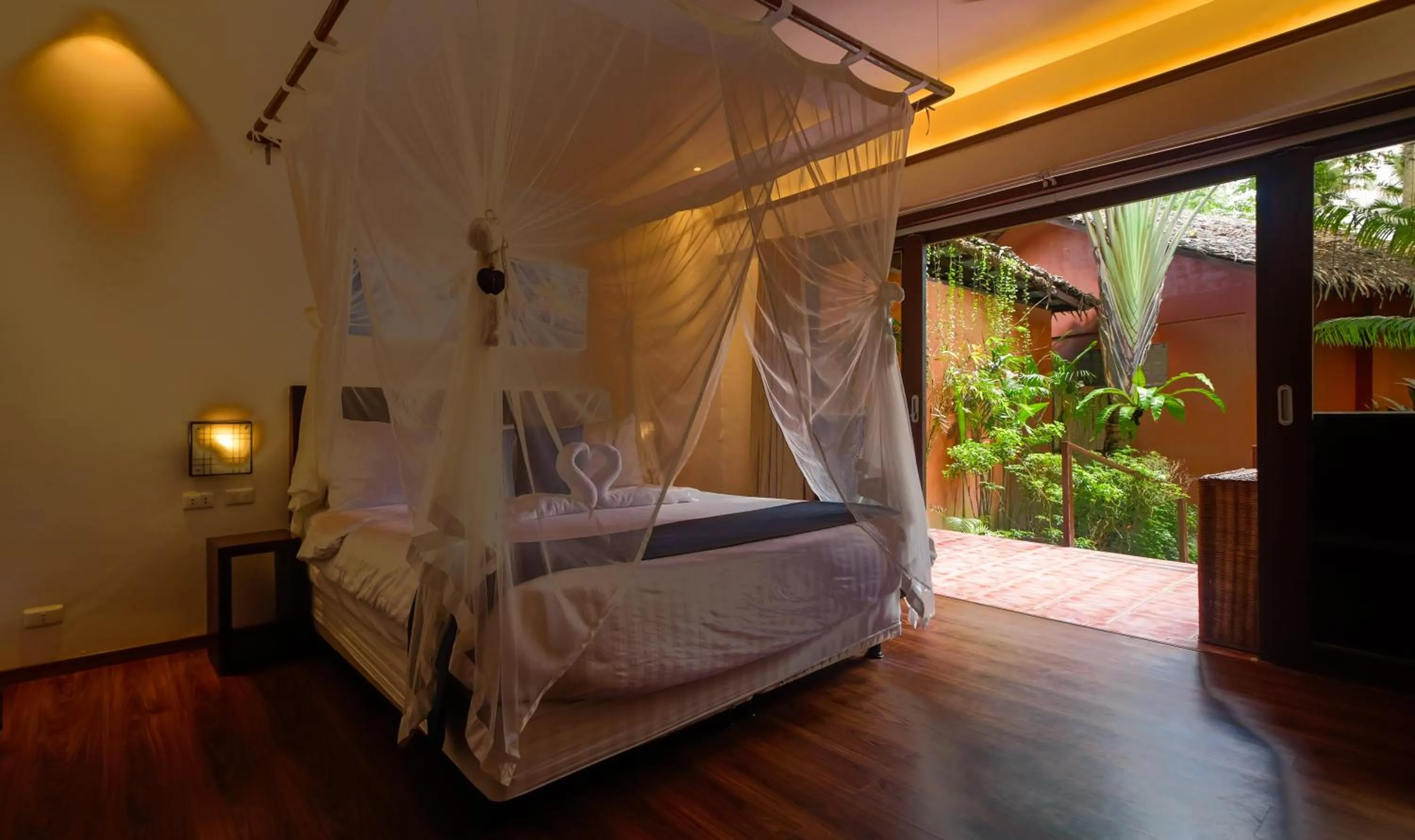 Bedroom, Bed in Last Frontier Beach Resort - Adults Only