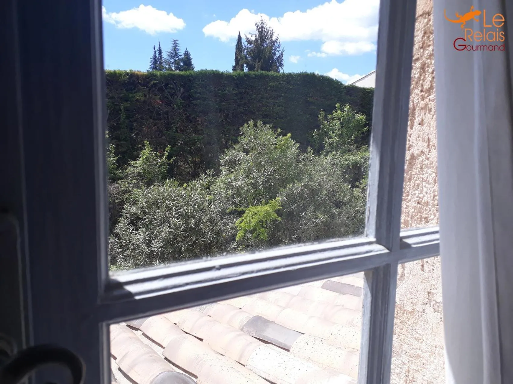 Garden view in Logis Hôtels La Bastide des Golfs
