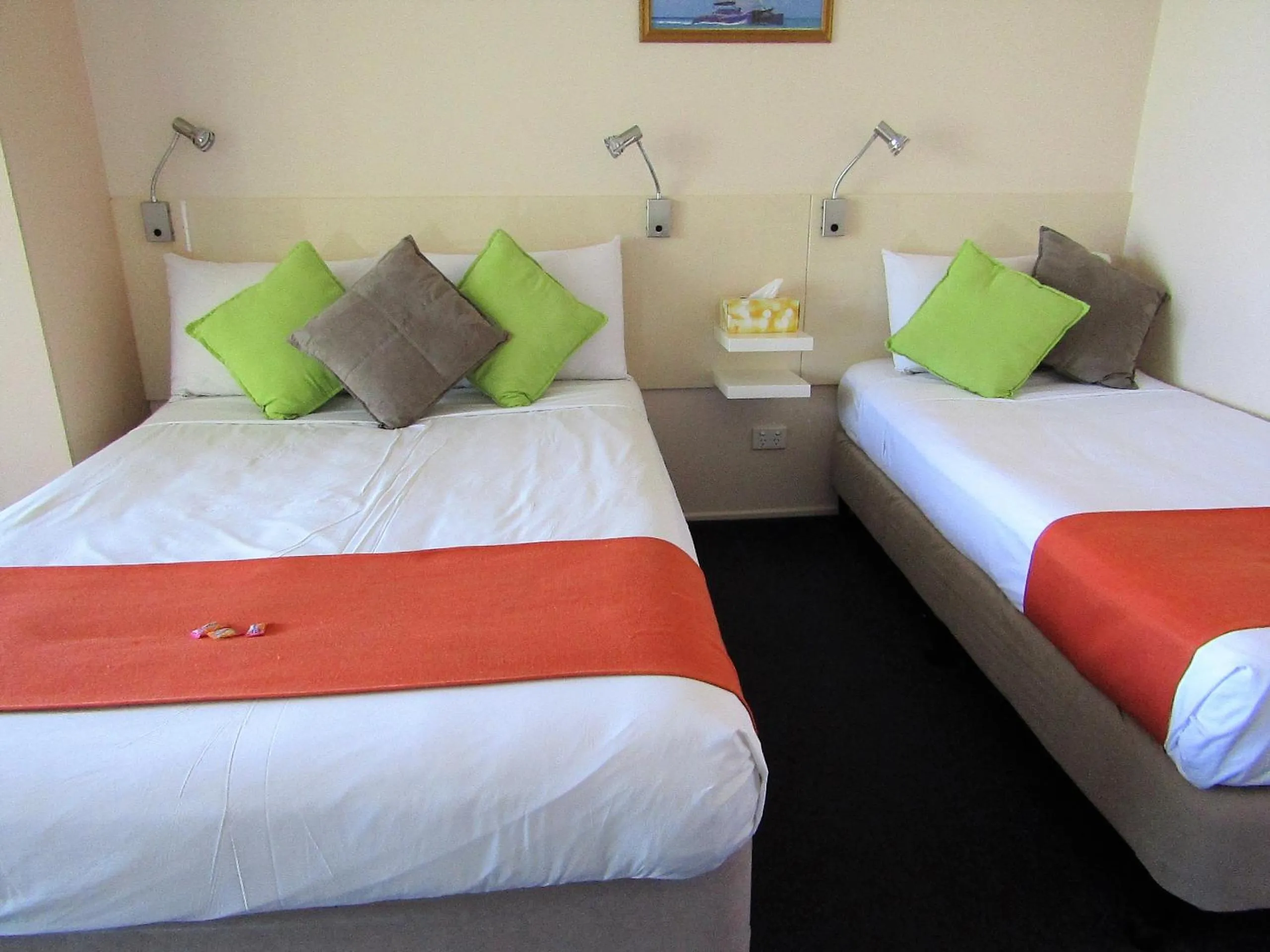 Bed in Sunlit Waters Studio Apartments