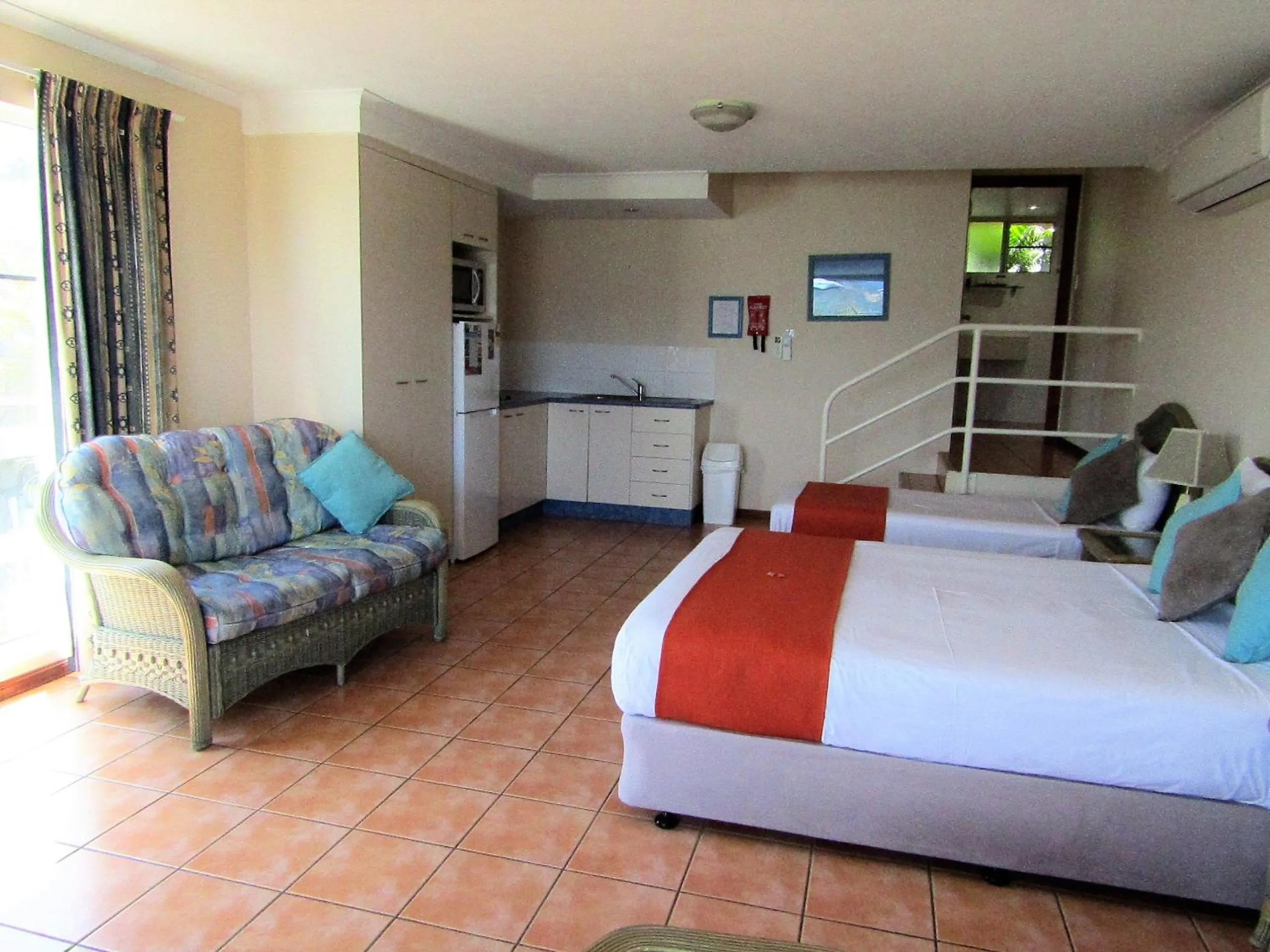 Bed in Sunlit Waters Studio Apartments