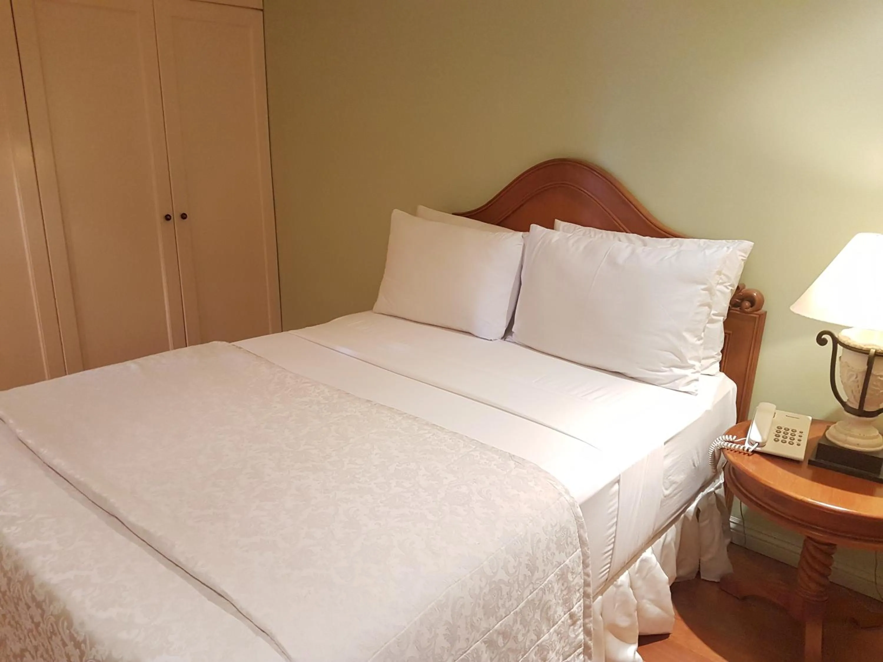Bed in Sophia Suites Residence Hotel