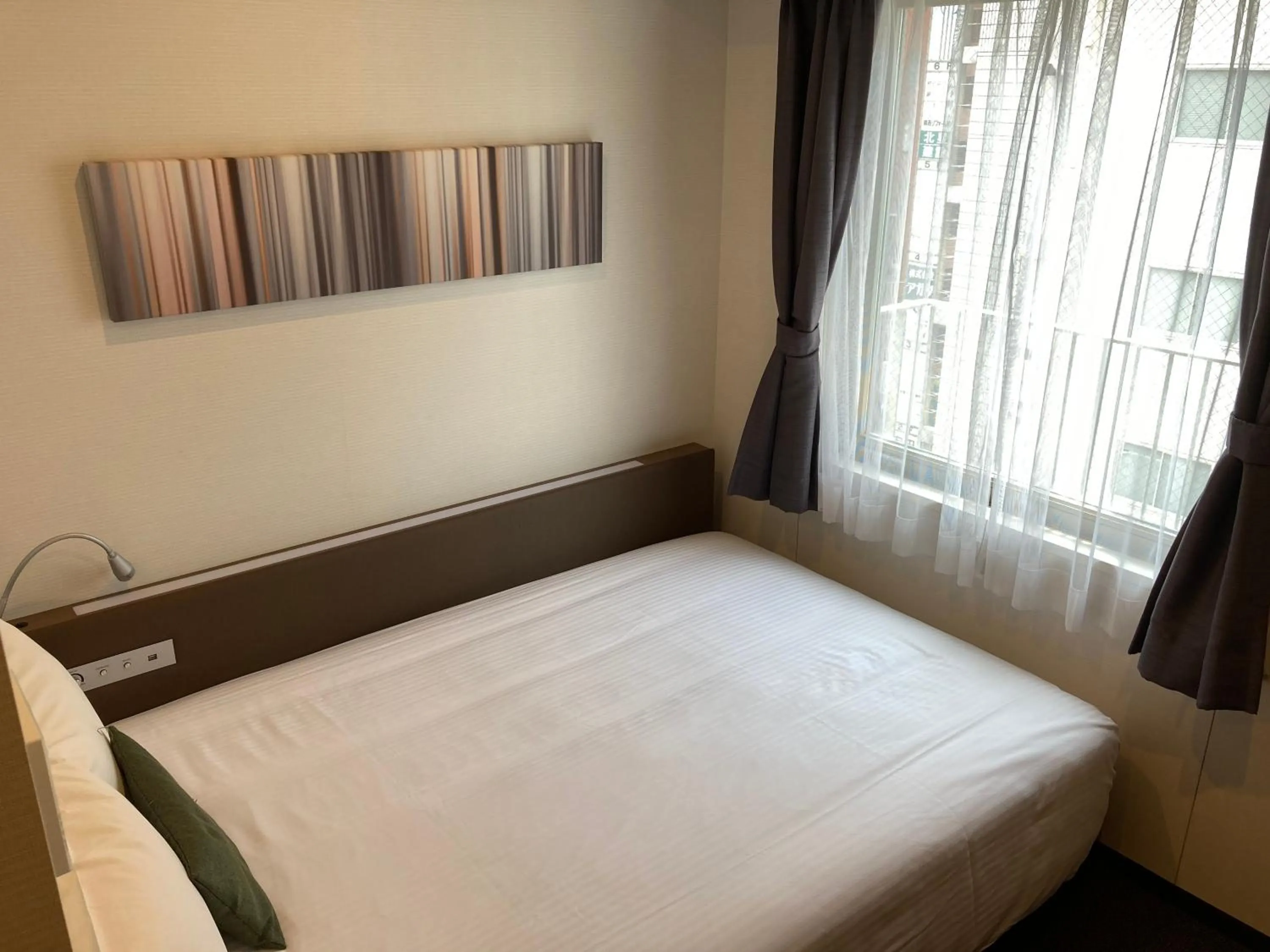 Bed in Y's HOTEL Shin Osaka