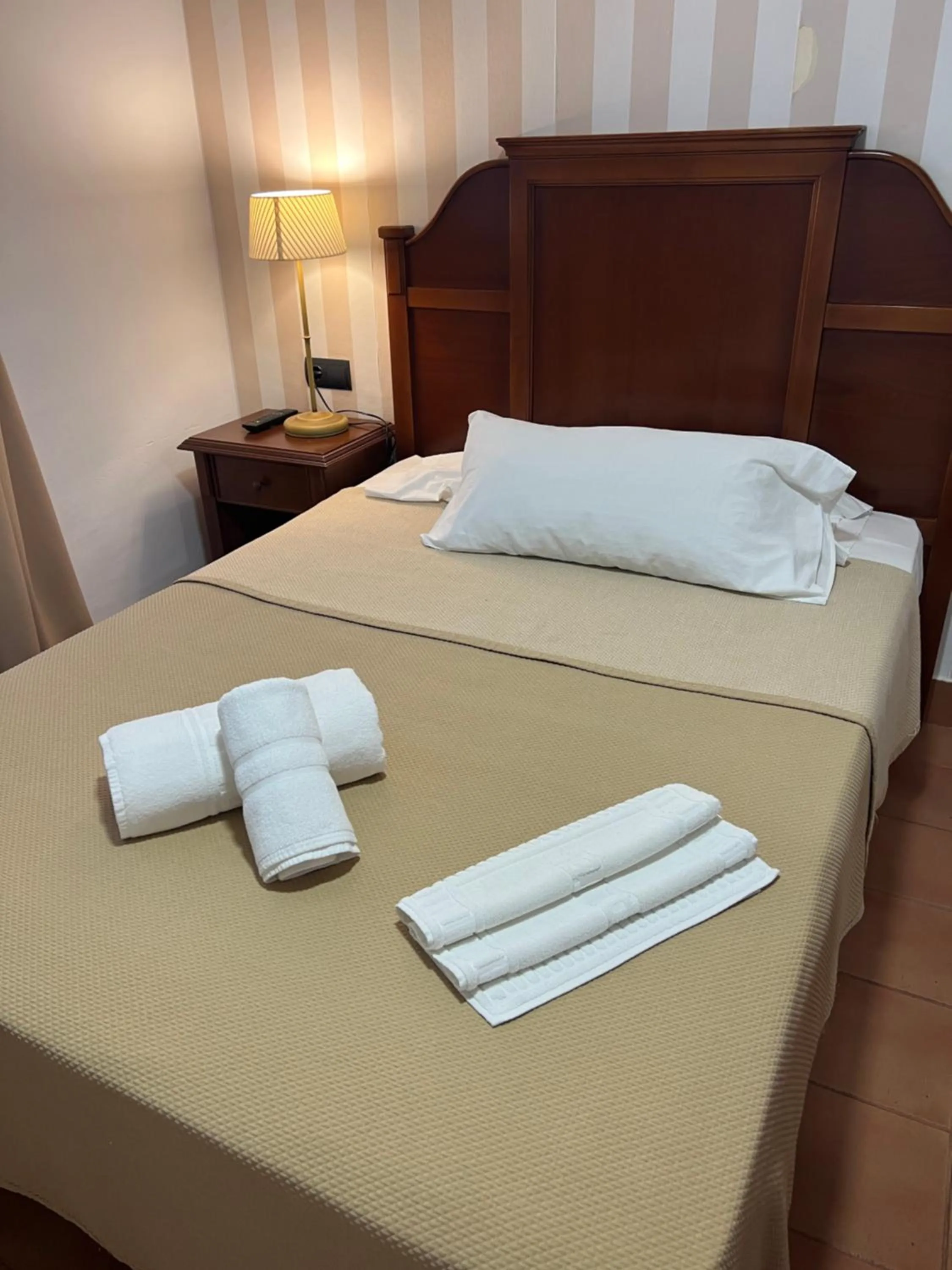 Bed in I AM La Posada Hotel and Apartment