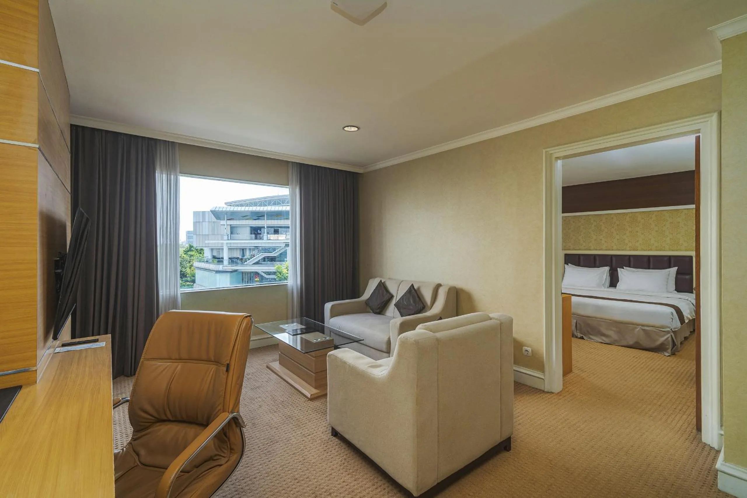 Living room, Bed in Surabaya Suites Hotel Powered by Archipelago