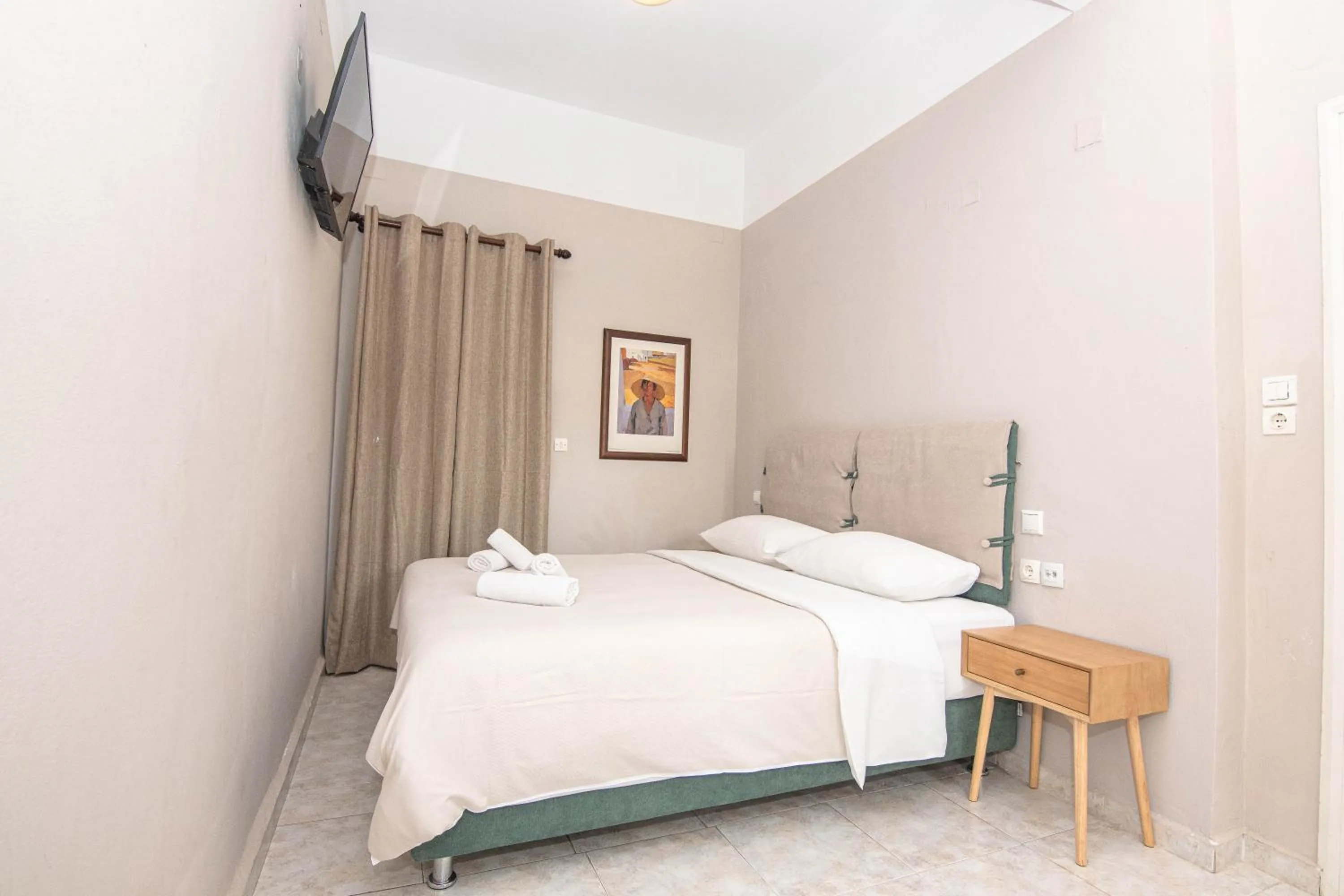 Bed in Talos Hotel Apartments